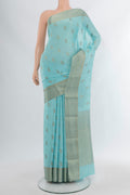 Sky Blue Mysore Crepe Saree with Zari Butta on the body and Zari Border.  displayed on a mannequin