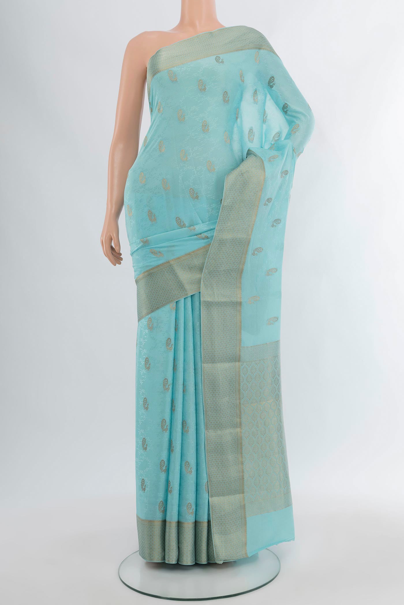 Sky Blue Mysore Crepe Saree with Zari Butta on the body and Zari Border.  displayed on a mannequin