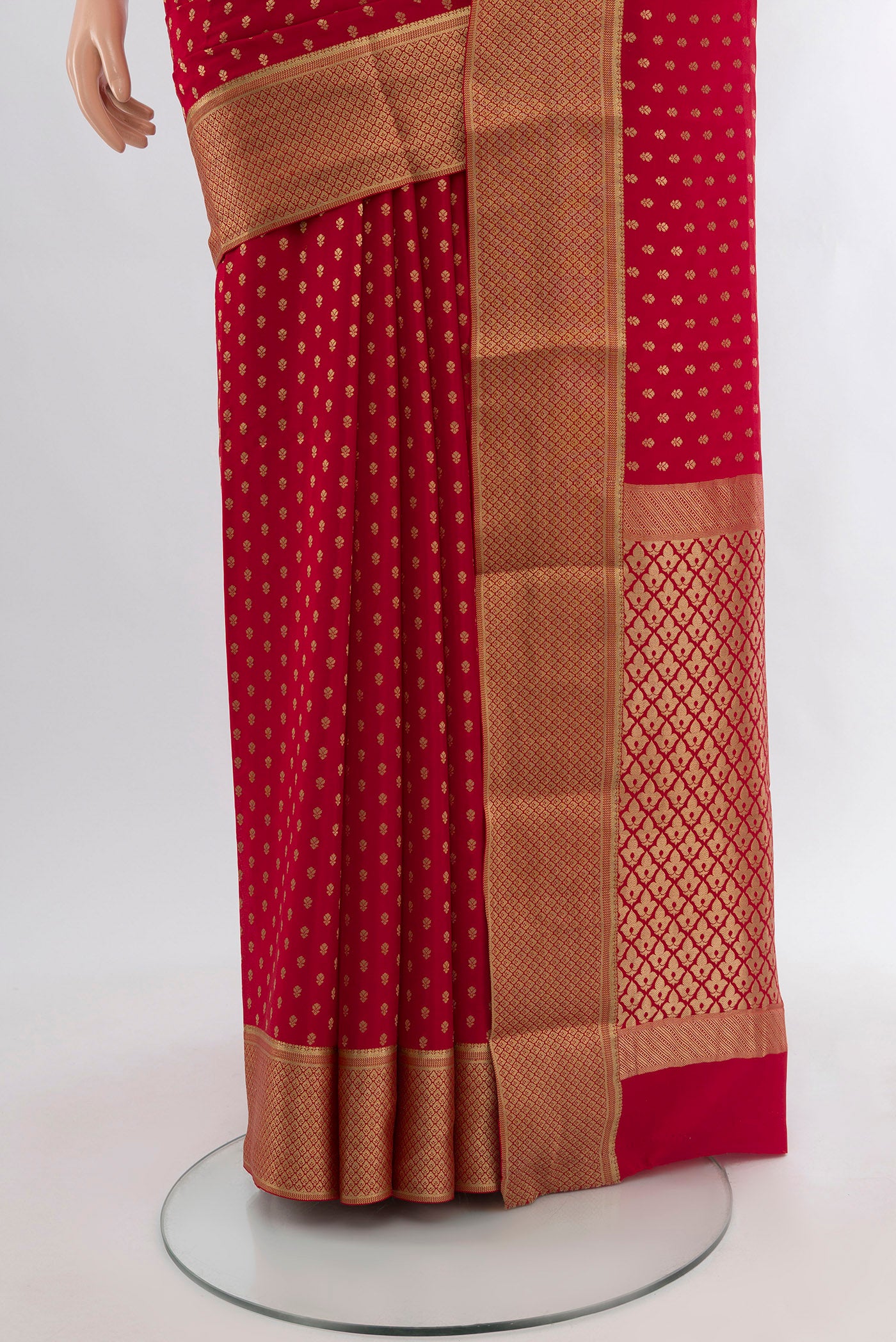 Pleats and pallu of Red Mysore Crepe Saree with Zari Butta on the body and Zari Border. 