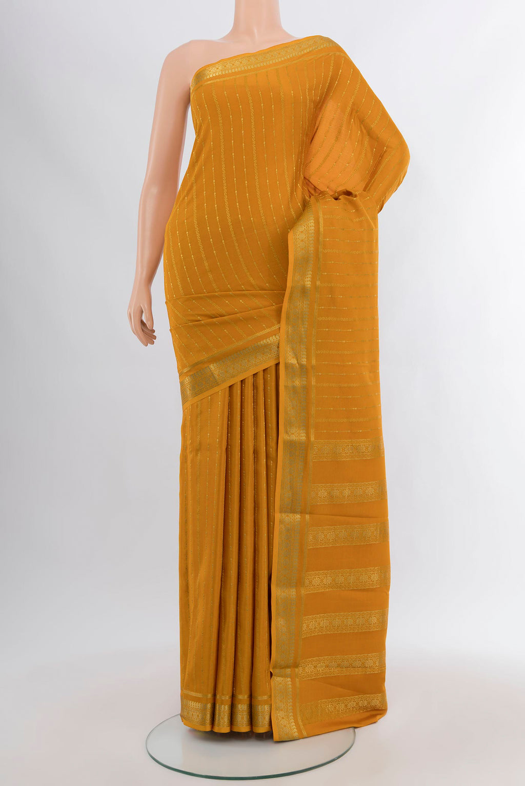 Mustard Mysore Crepe Saree with Zari Butta on the body and Zari Border.  displayed on a mannequin