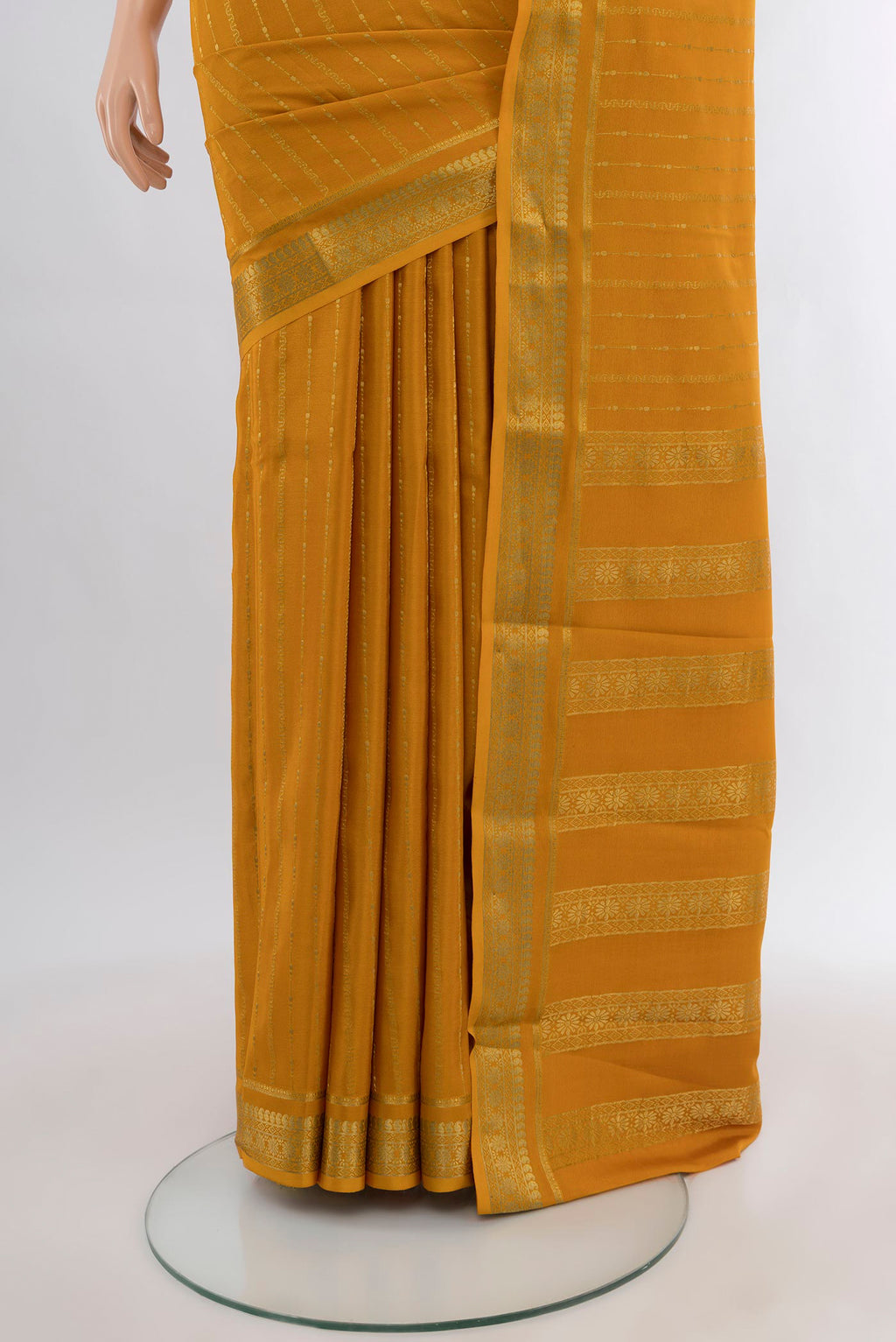 Pleats and pallu of Mustard Mysore Crepe Saree with Zari Butta on the body and Zari Border. 