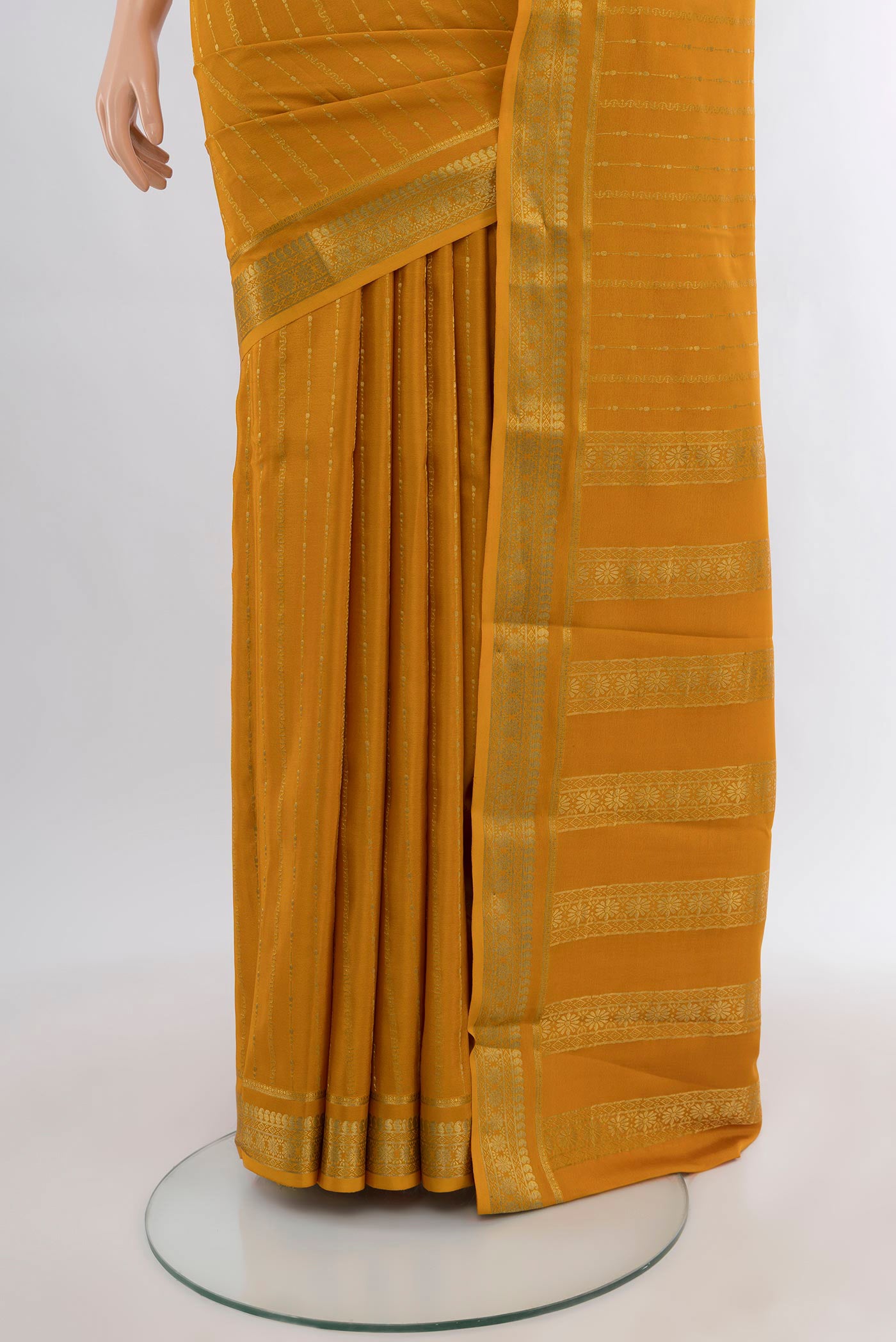 Pleats and pallu of Mustard Mysore Crepe Saree with Zari Butta on the body and Zari Border. 