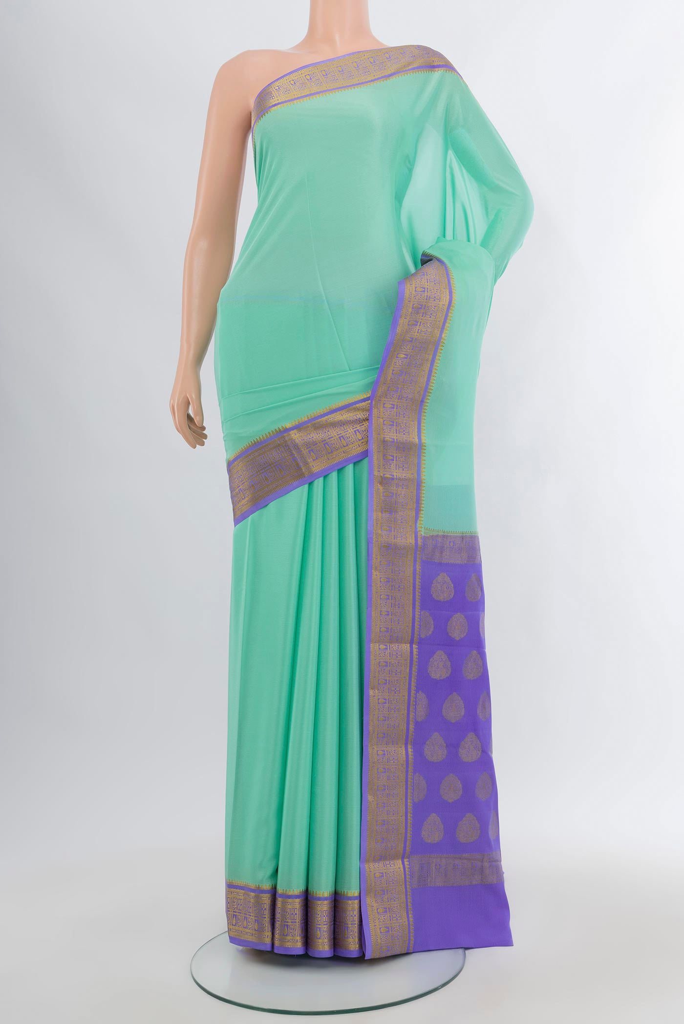 Sea Green Mysore Crepe Saree with Plain Body and Zari Border.  displayed on a mannequin