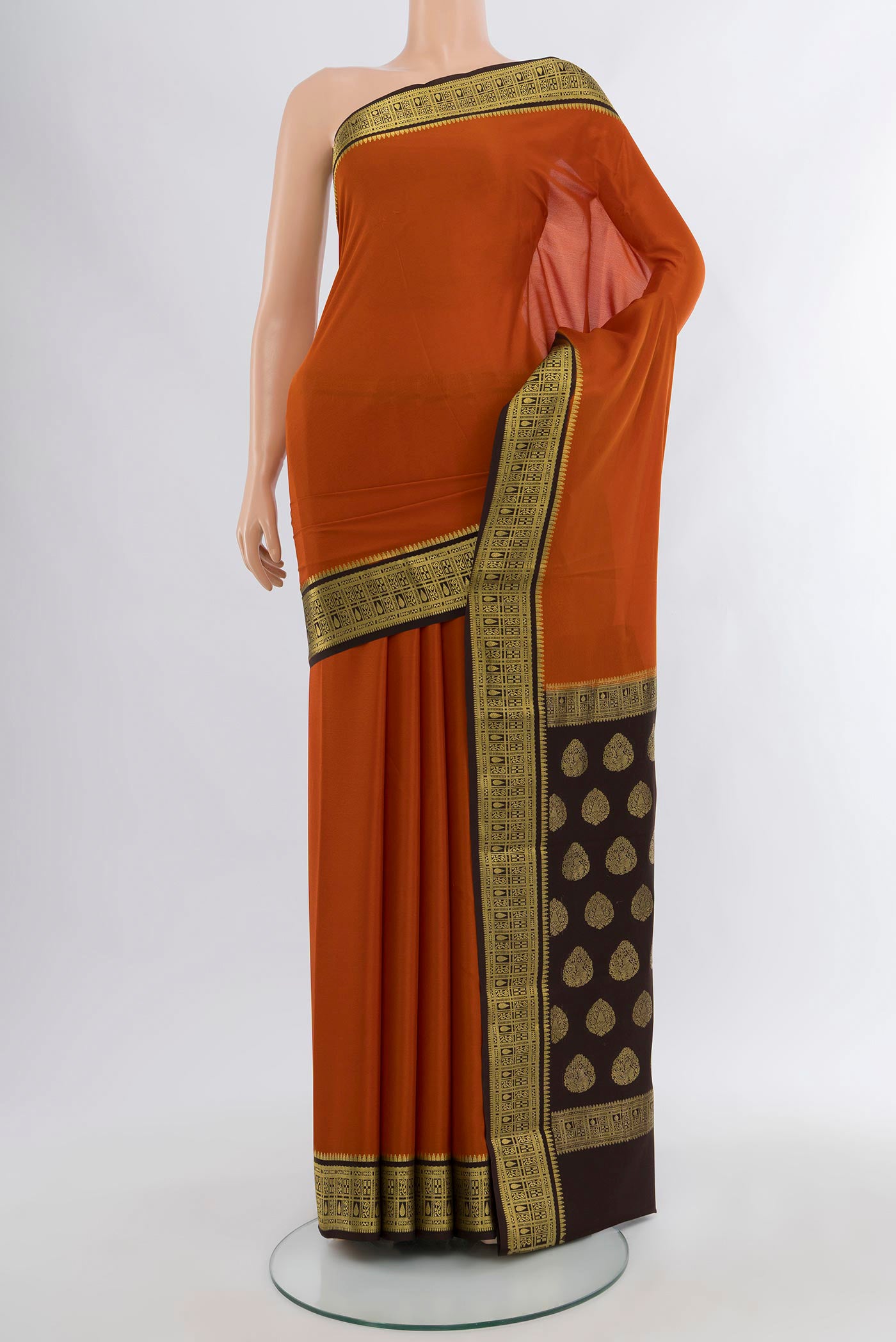 Rust Mysore Crepe Saree with Plain Body and Zari Border.  displayed on a mannequin