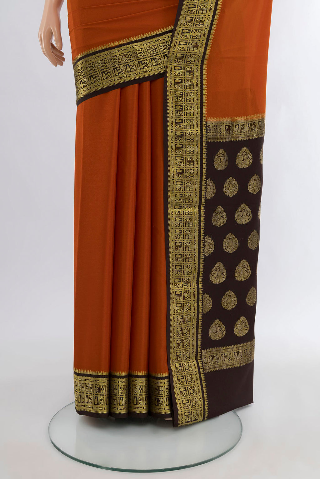 Pleats and pallu of Rust Mysore Crepe Saree with Plain Body and Zari Border. 