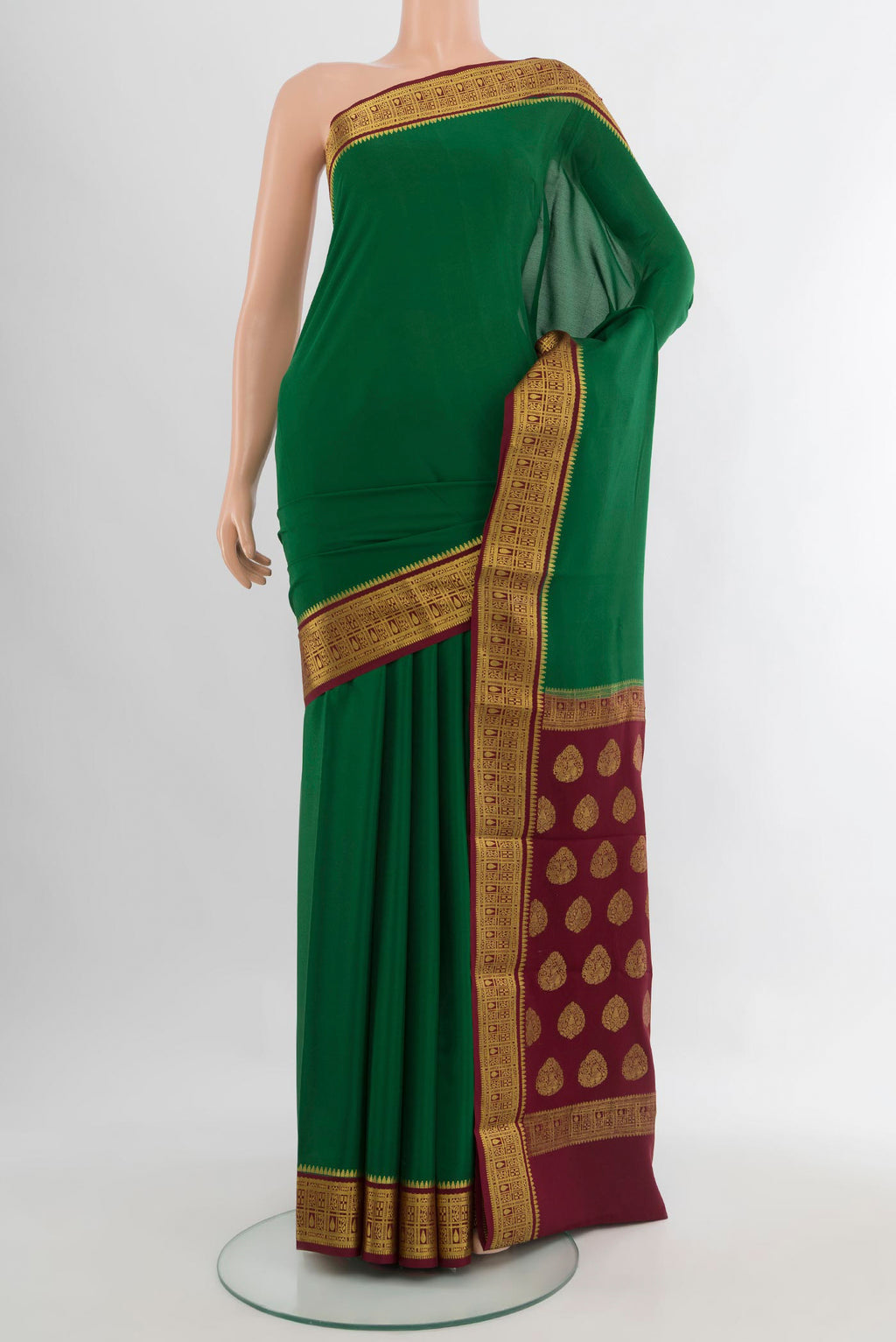 Green Mysore Crepe Saree with Plain Body and Zari Border.  displayed on a mannequin