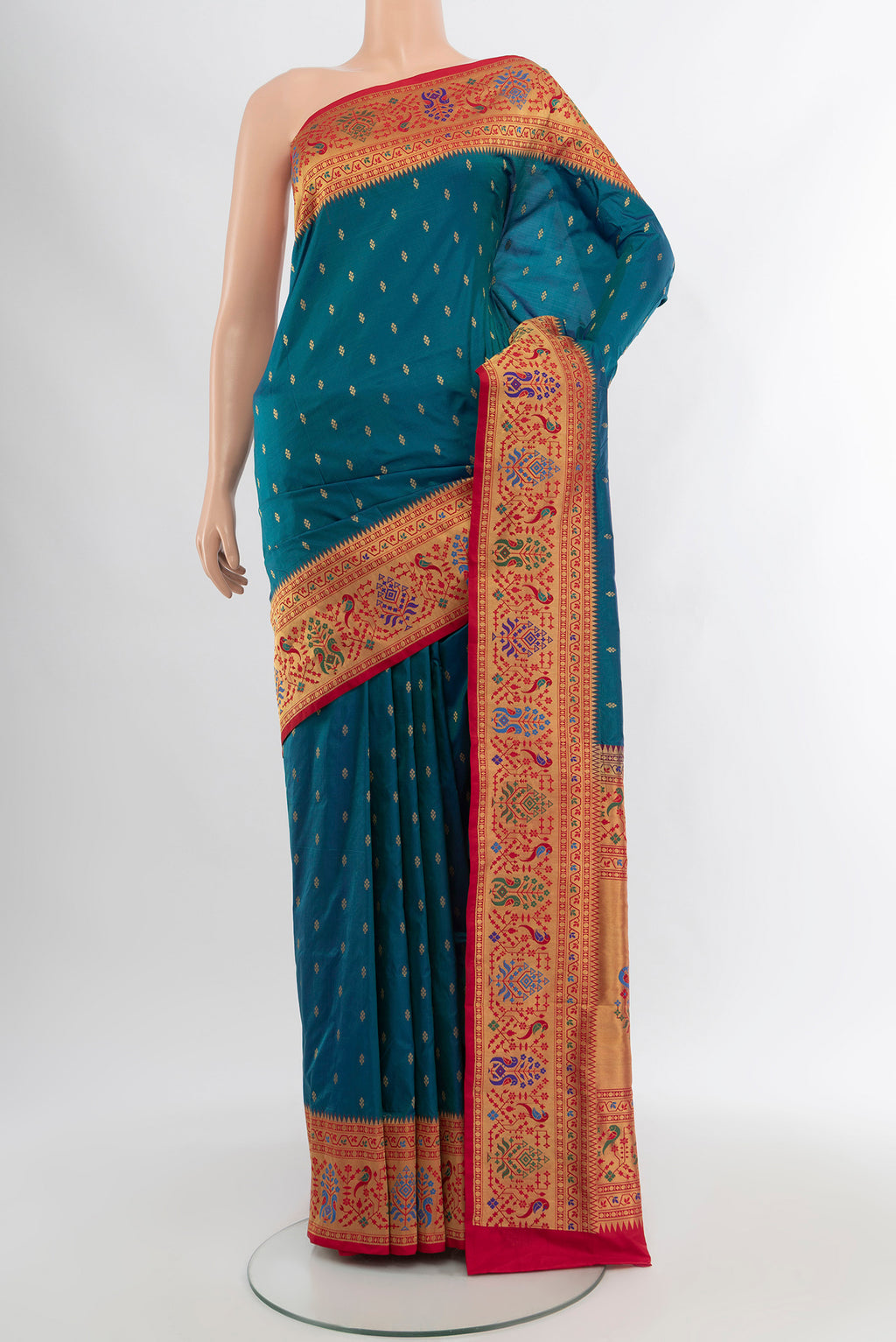 Peacock Blue Soft Silk Saree with Zari Butta on the body and Silk Border.  displayed on a mannequin