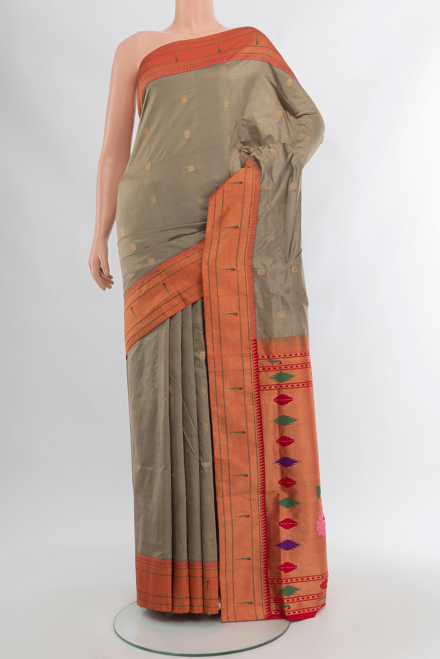 Beige Soft Silk Saree with Zari Butta on the body and Silk Border.  displayed on a mannequin