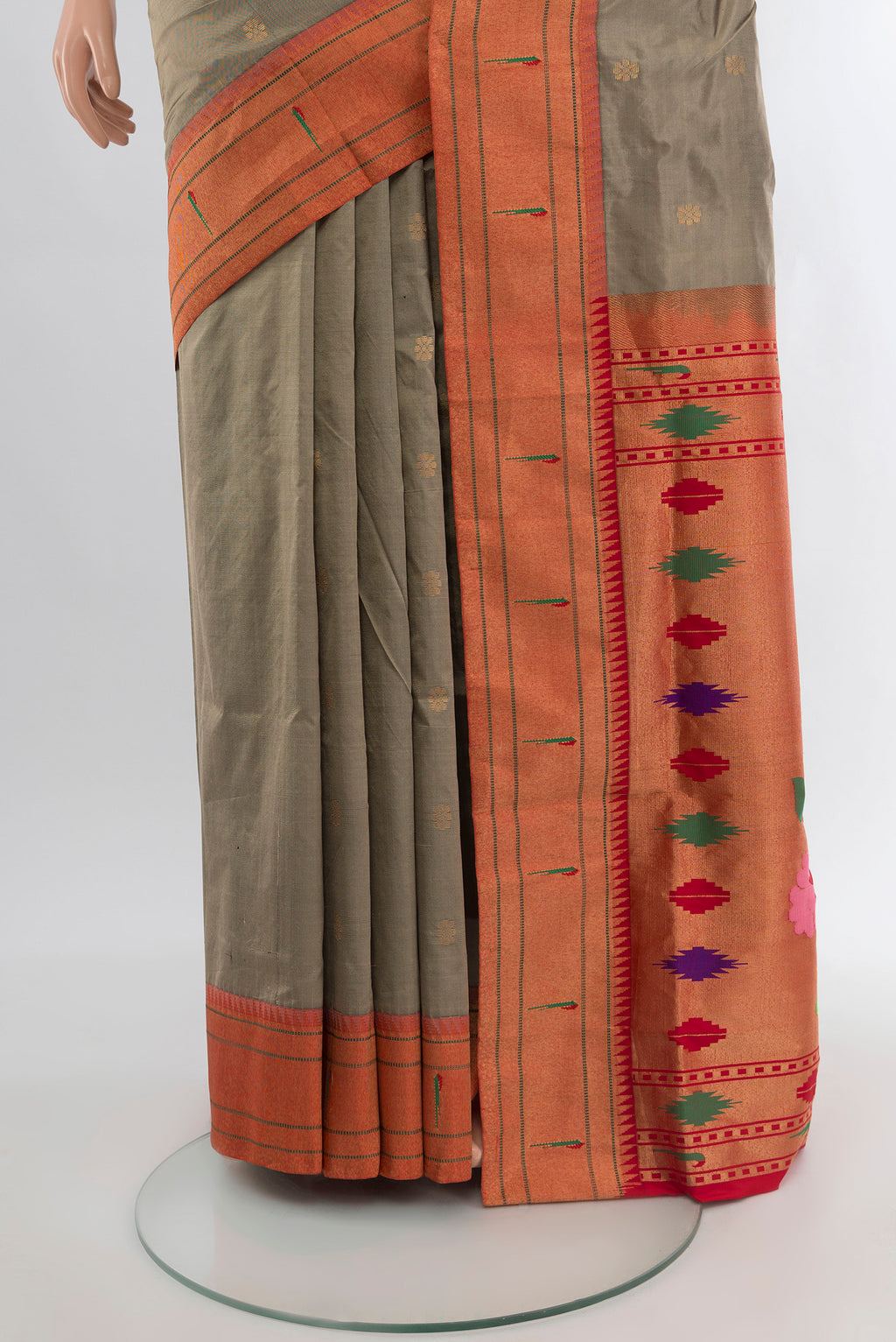 Pleats and pallu of Beige Soft Silk Saree with Zari Butta on the body and Silk Border. 