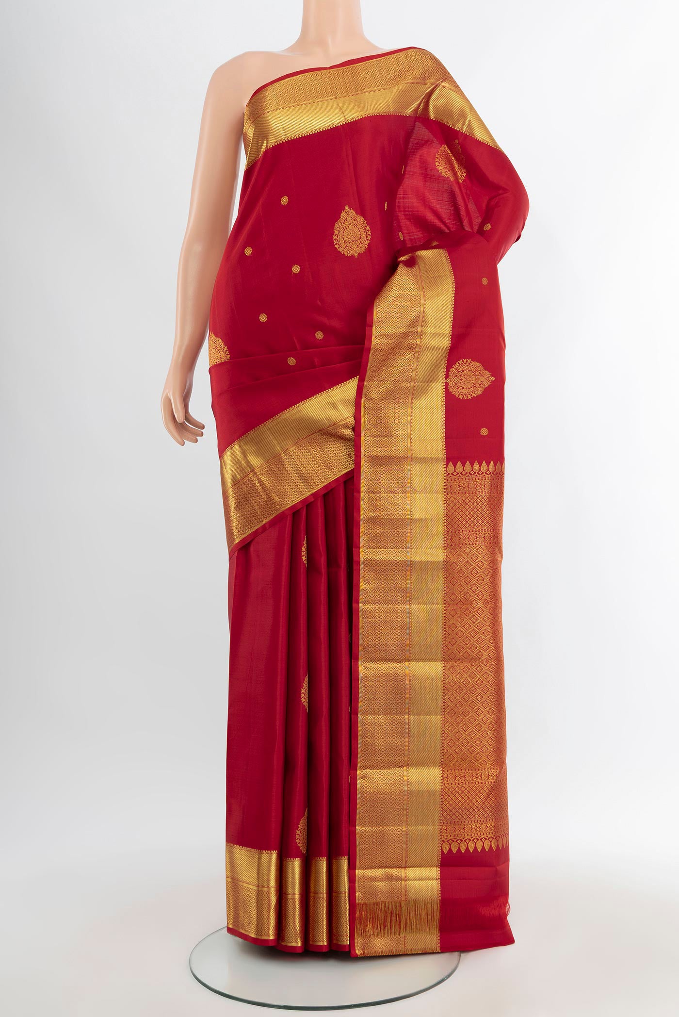 Maroon Kanjivaram Silk Saree with Zari Butta on the body and Zari Border.  displayed on a mannequin