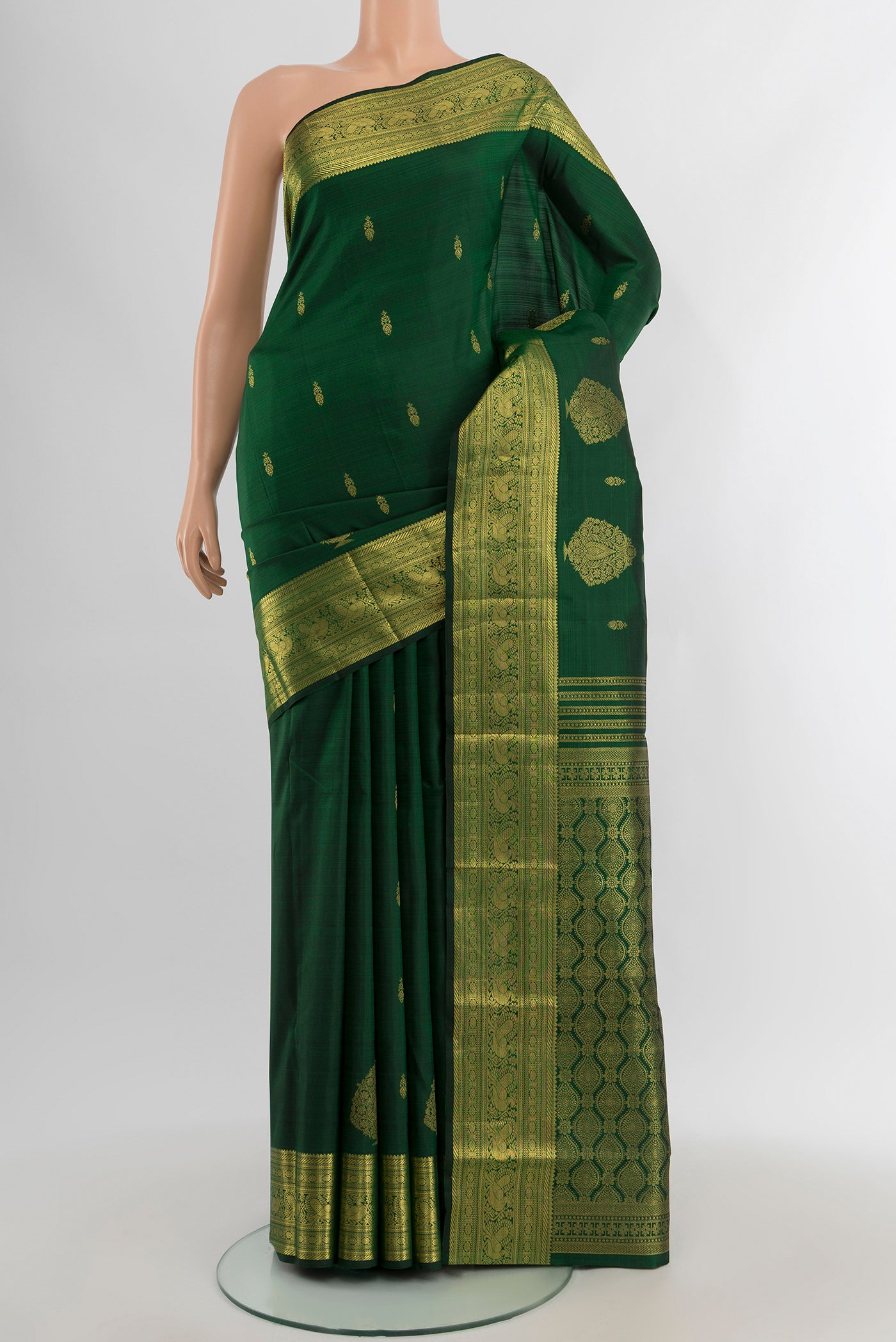 Bottle Green Kanjivaram Silk Saree with Zari Butta on the body and Zari Border.  displayed on a mannequin
