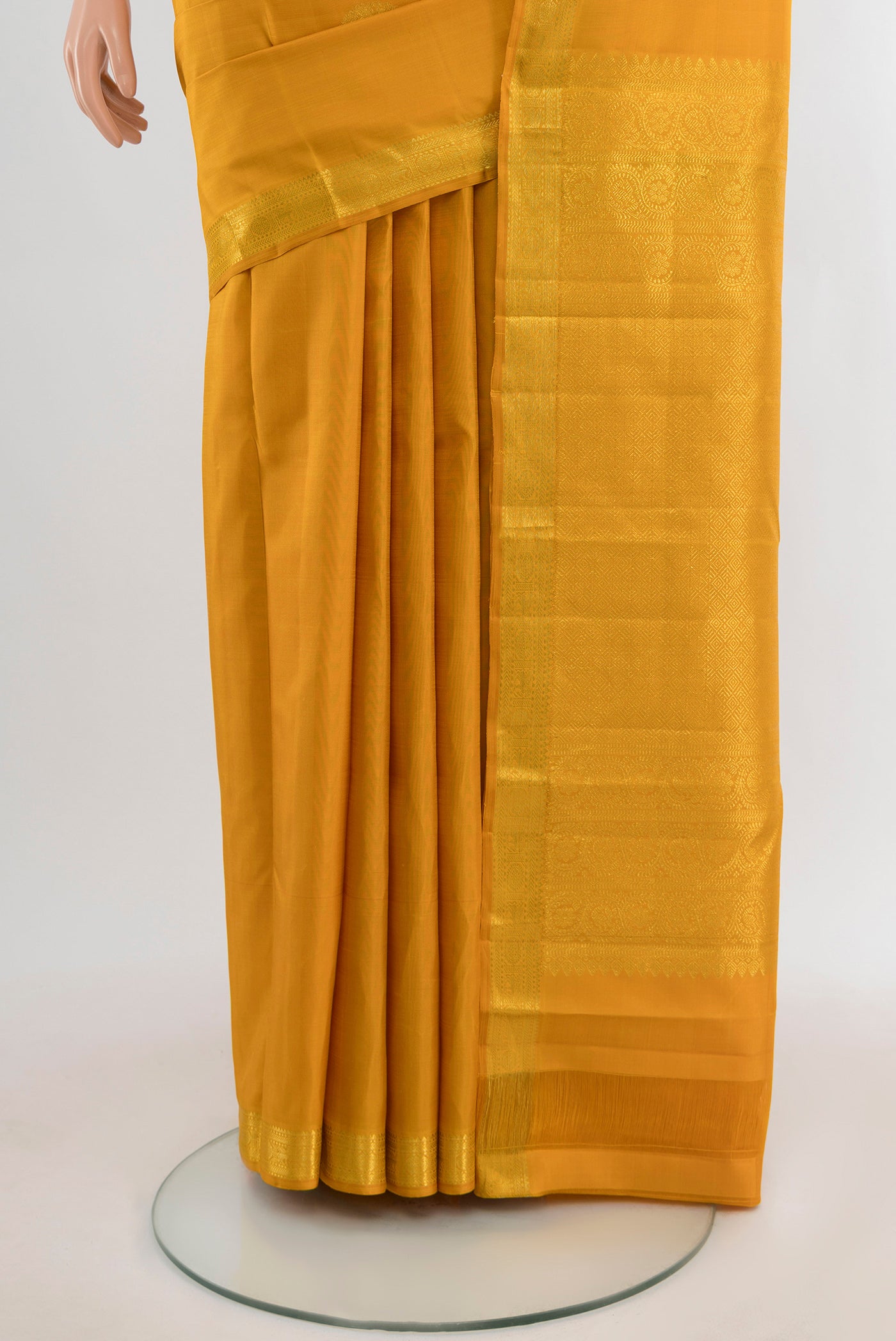 Pleats and pallu of Mustard Kanchipuram Silk Saree with Zari Butta on the body and Zari Border. 