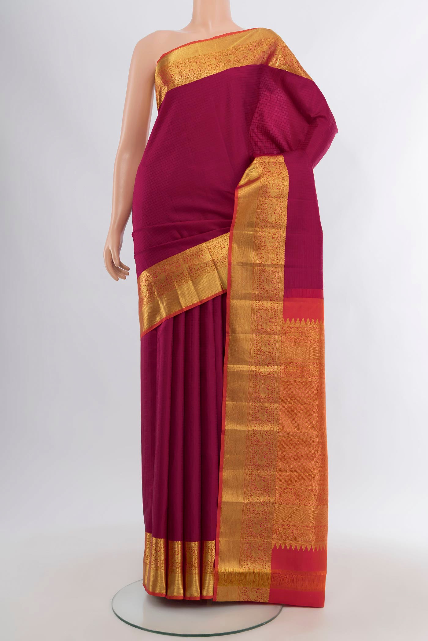 Maroon Kanjivaram Silk Saree with Checked design on the body and Zari Border.  displayed on a mannequin