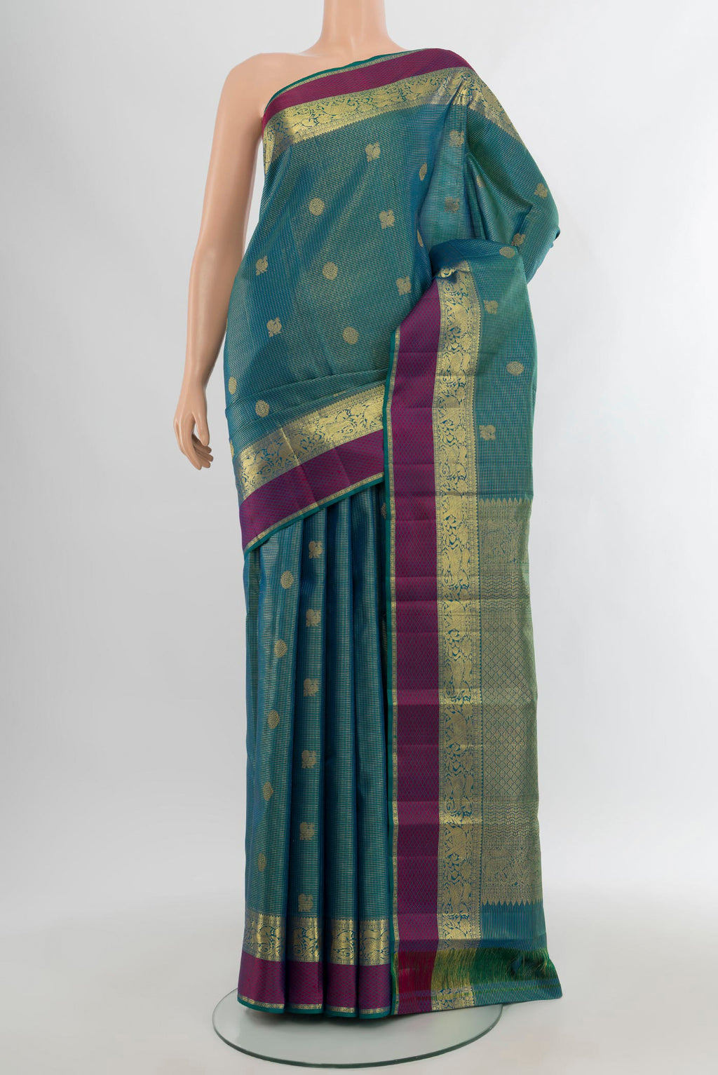 Peacock Blue Kanjivaram Silk Saree with Zari Butta on the body and Zari Border.  displayed on a mannequin