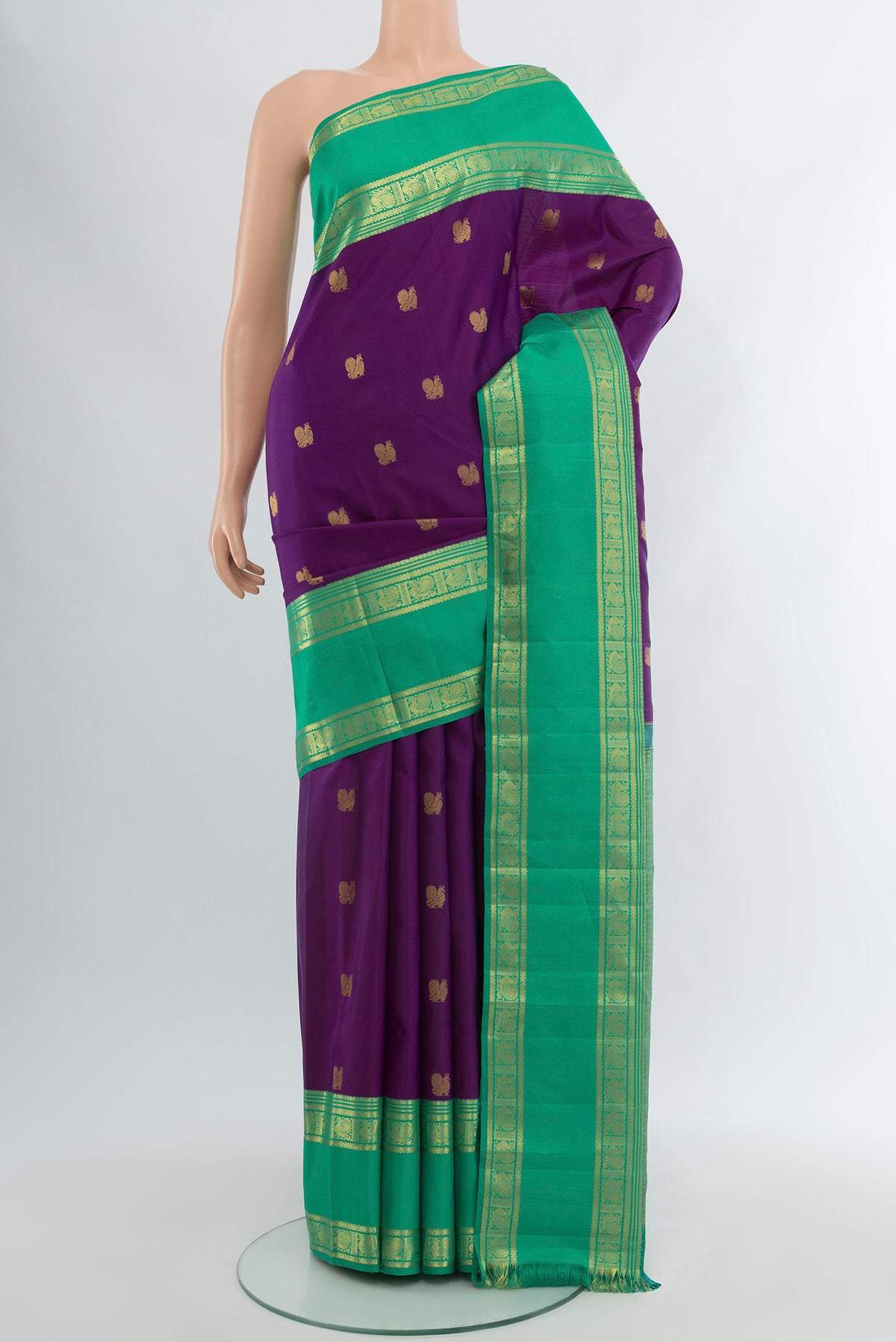 Violet Kanjivaram Silk Saree with Zari Butta on the body and Zari Border.  displayed on a mannequin