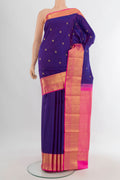 Pure Silk Violet Kanjivaram Saree with Zari Butta on the body and Zari Border.  displayed on a mannequin