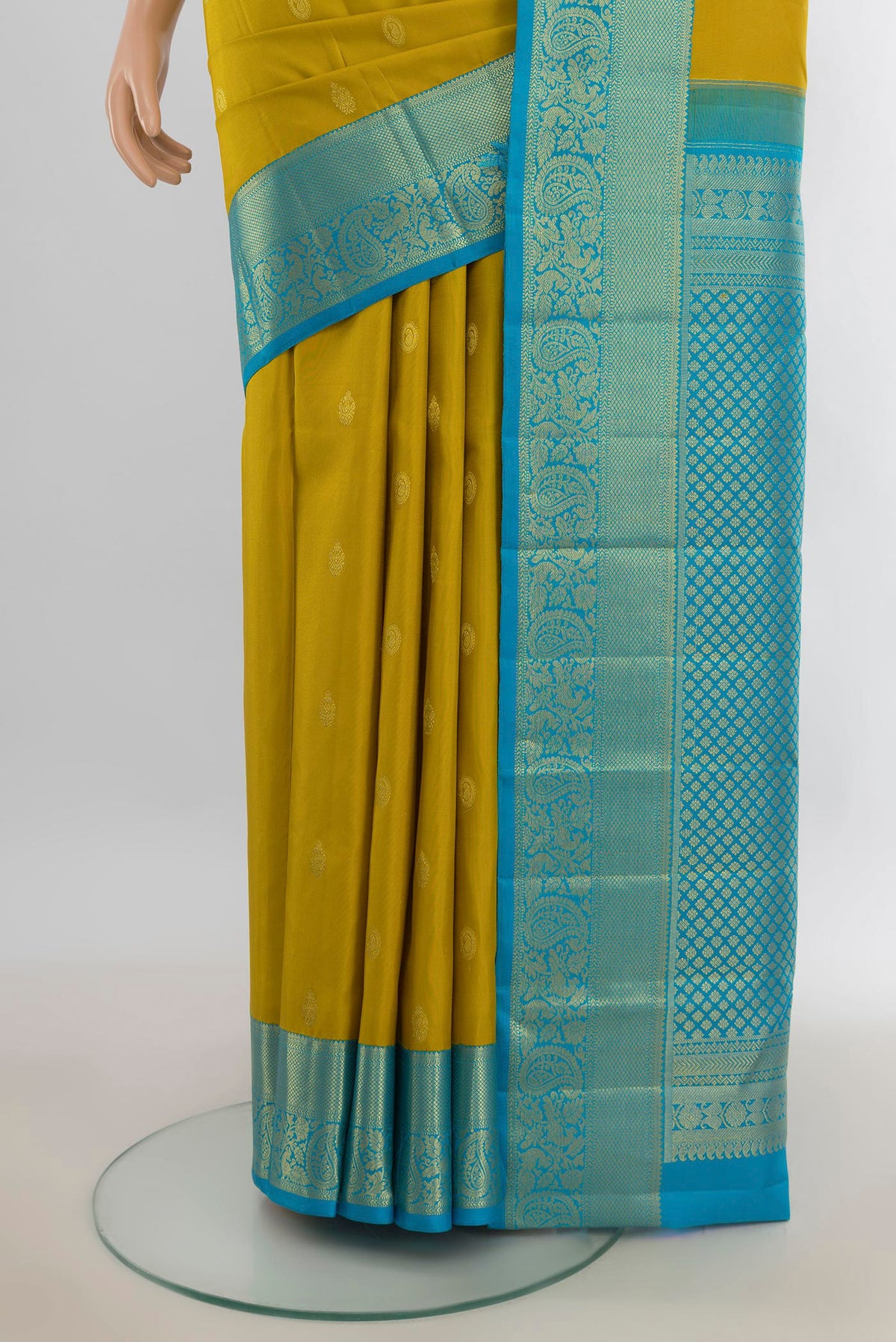 Pleats and pallu of Pure Silk Yellow Kanjivaram Saree with Zari Butta on the body and Silk Border. 