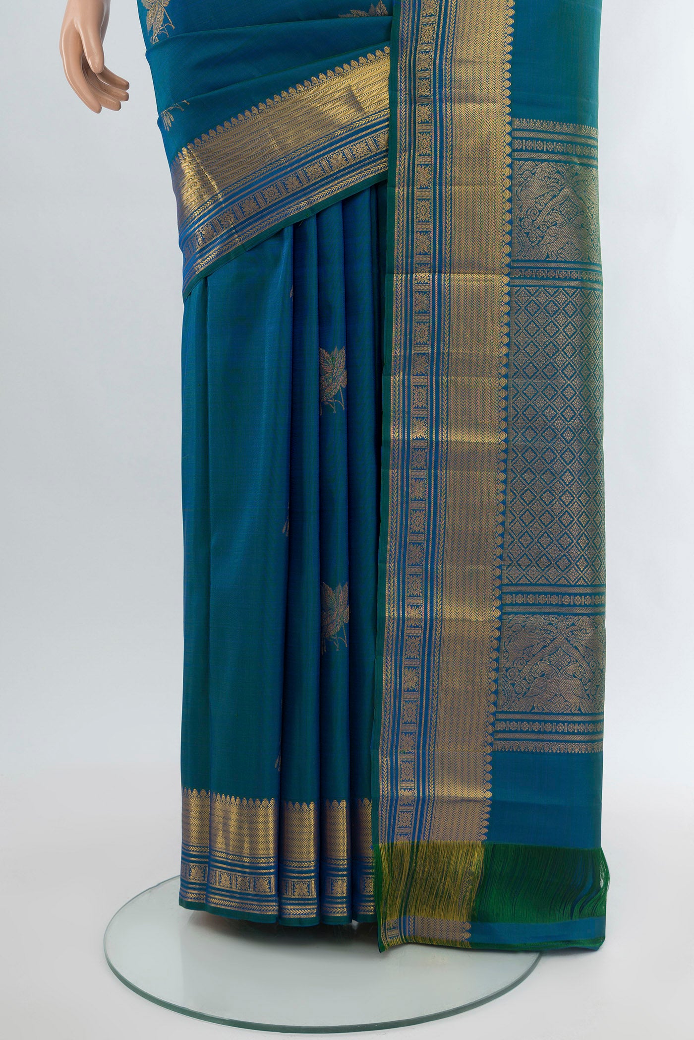 Pleats and pallu of Peacock Blue Kanchipuram Silk Saree with Zari Butta on the body and Zari Border. 