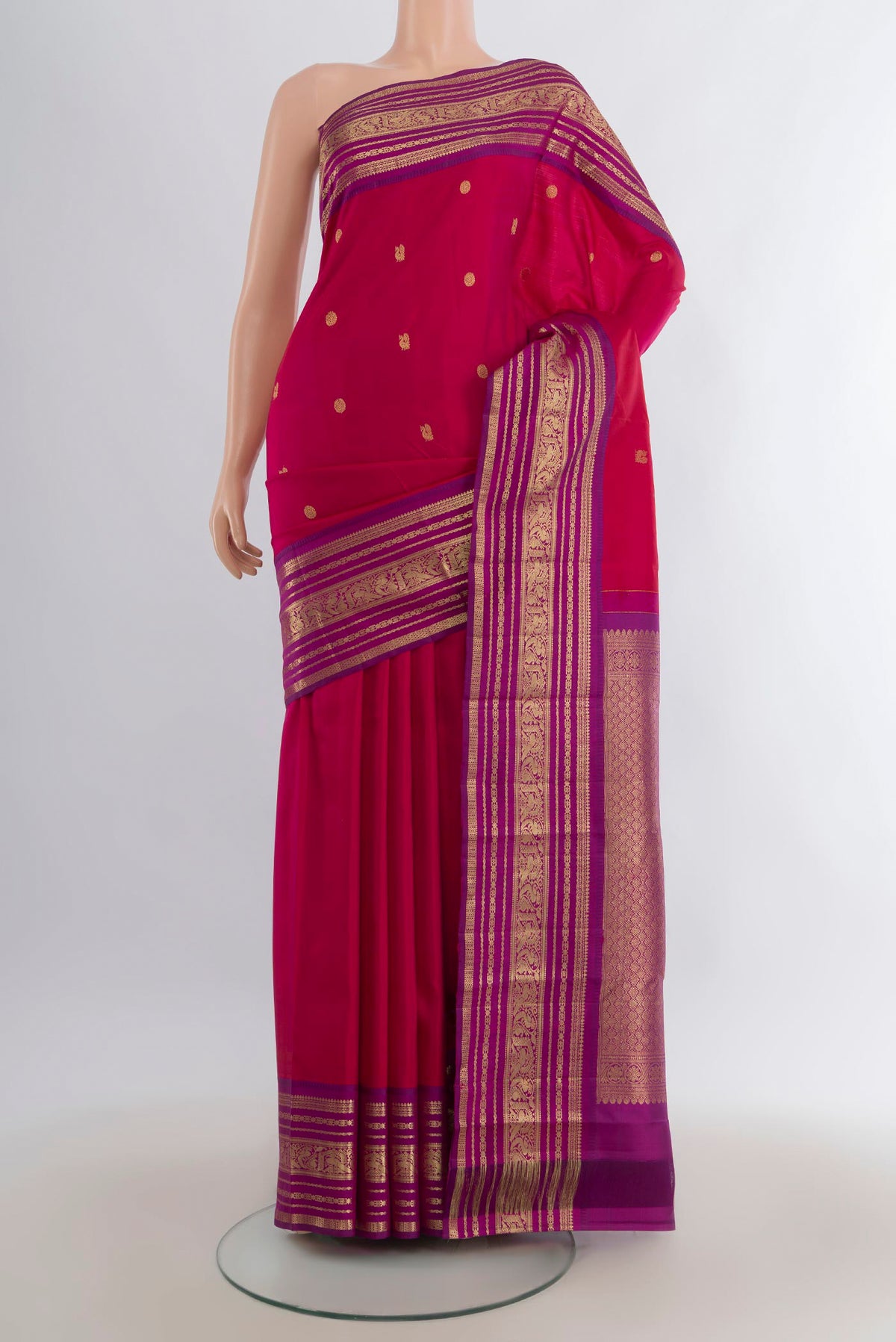 Pure Silk Dark Pink Kanjivaram Saree with Zari Butta on the body and Zari Border.  displayed on a mannequin