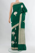 Bottle Green Banarasi Silk Saree with Zari Butta on the body and Zari Border.  displayed on a mannequin