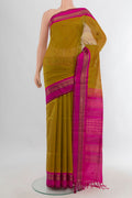 Mehandi Green Silk Cotton Saree with Zari Butta on the body and Zari Border.  displayed on a mannequin