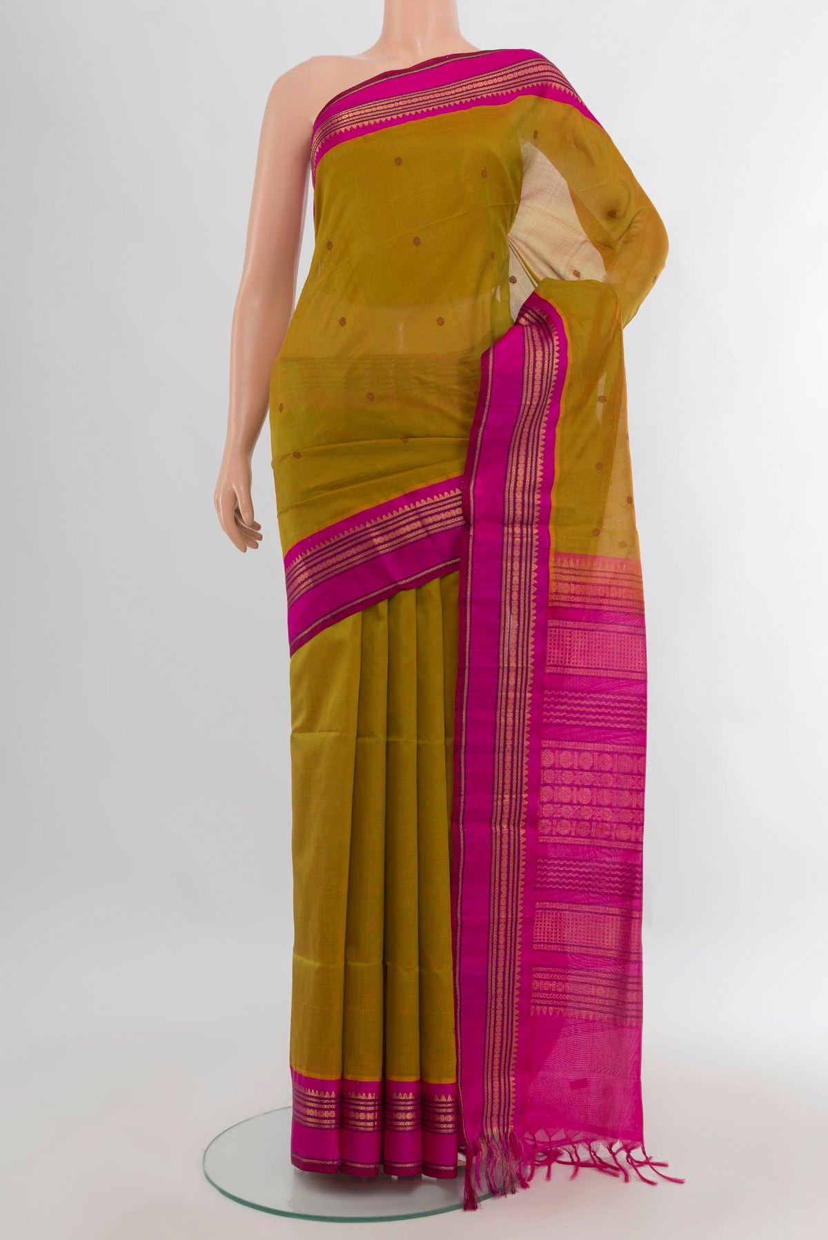 Mehandi Green Silk Cotton Saree with Zari Butta on the body and Zari Border.  displayed on a mannequin