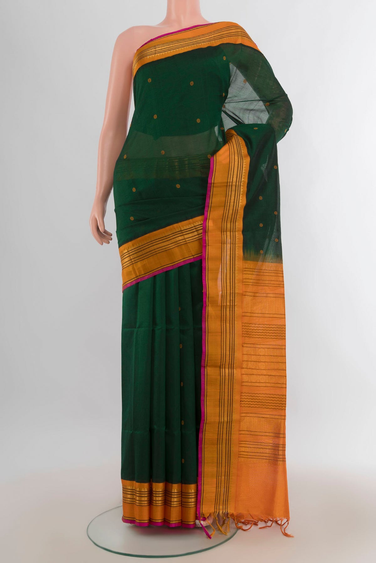 Mint Green Silk Cotton Saree with Zari Butta on the body and Silk Border.  displayed on a mannequin