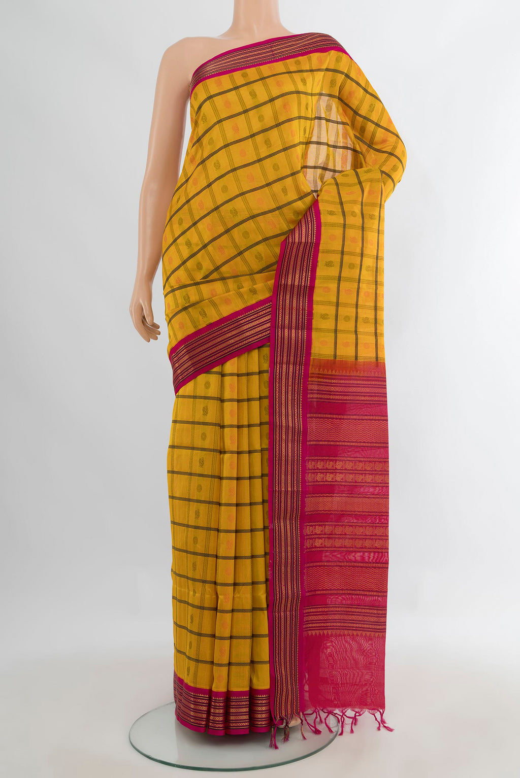 Yellow Silk Cotton Saree with Checked design on the body and Zari Border.  displayed on a mannequin