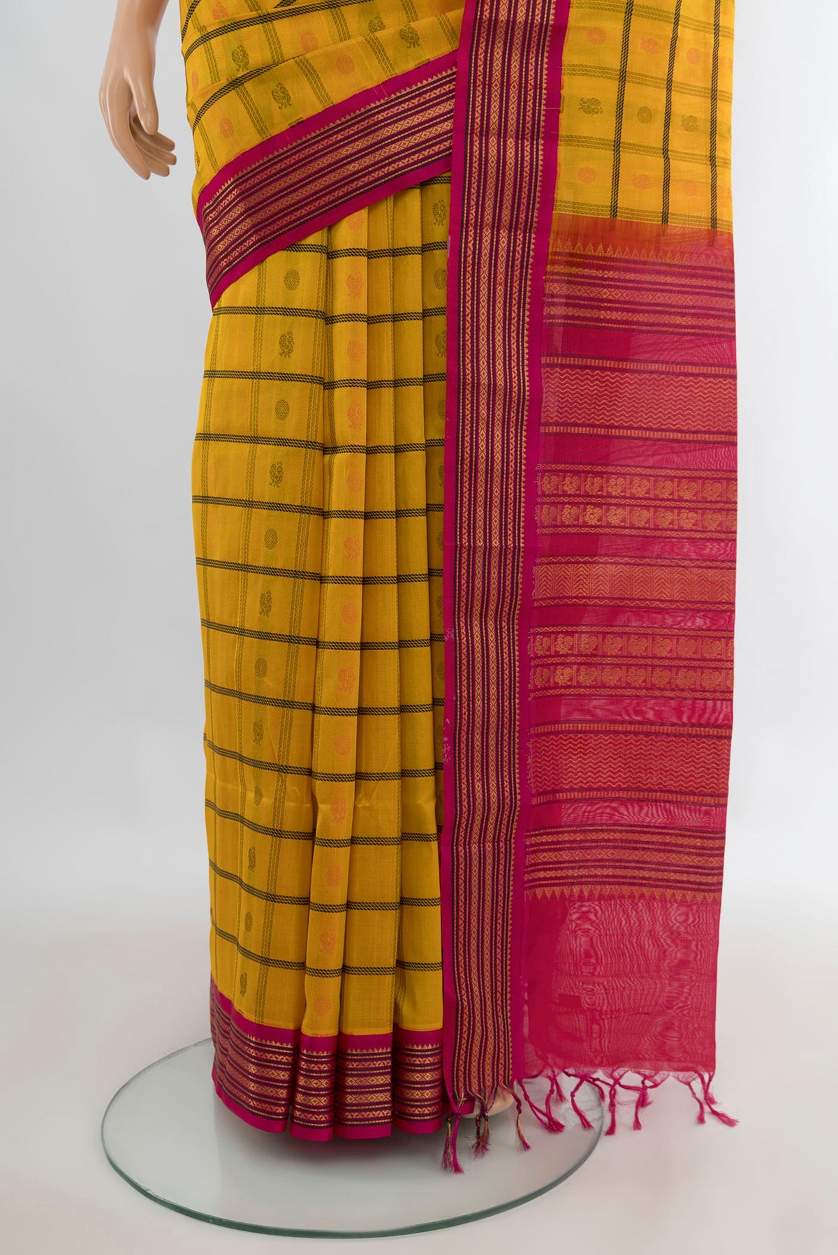 Pleats and pallu of Yellow Silk Cotton Saree with Checked design on the body and Zari Border. 