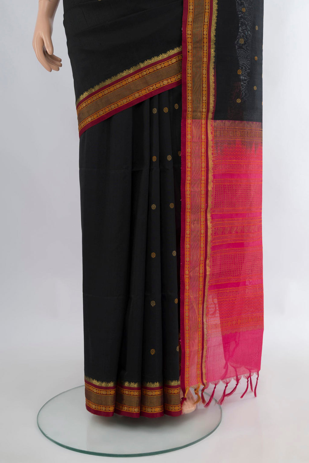 Pleats and pallu of Black Silk Cotton Saree with Zari Butta on the body and Zari Border. 