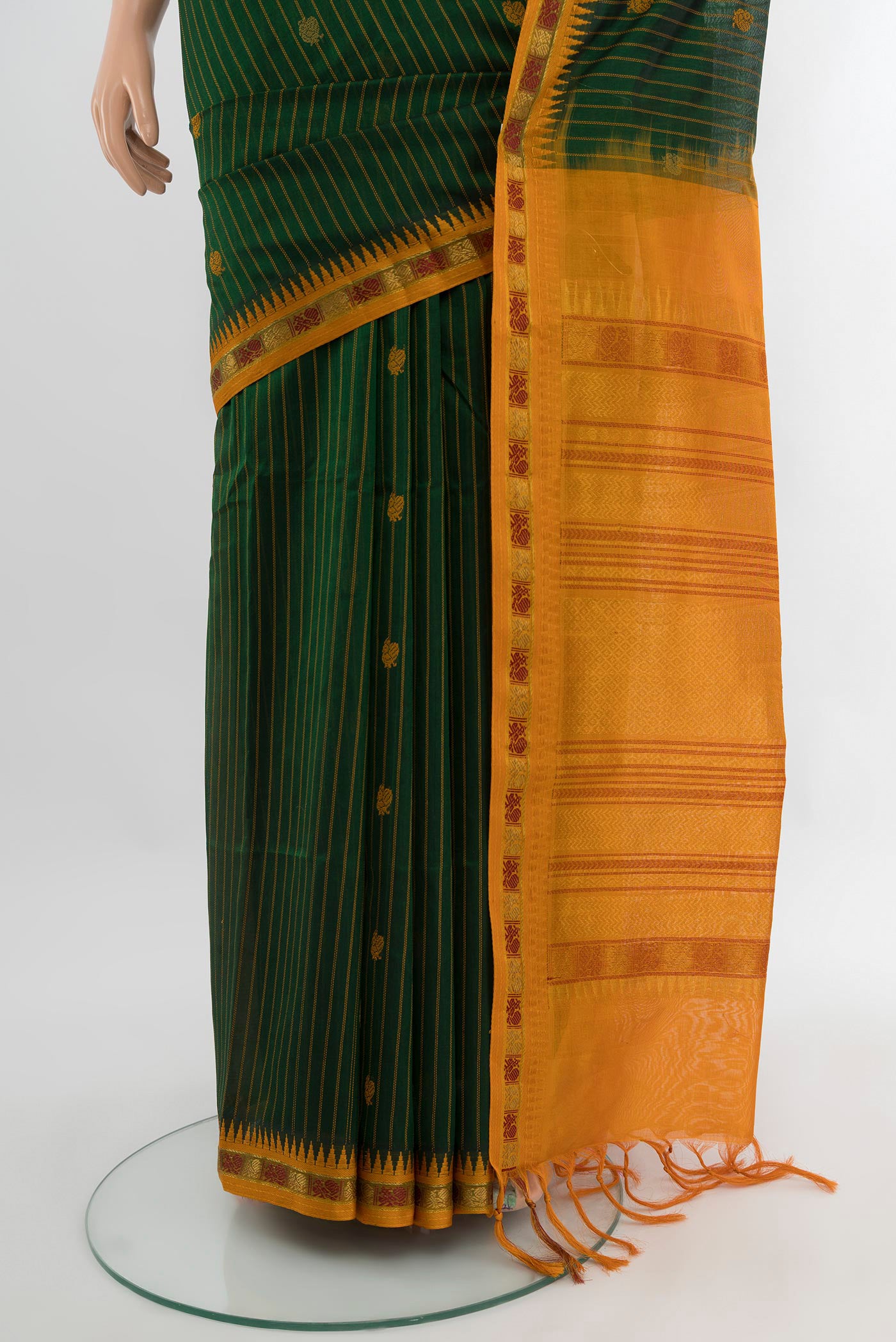 Pleats and pallu of Bottle Green Silk Cotton Saree with Stripes on the body and Zari Border. 