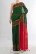 Bottle Green Silk Cotton Saree with Checked design on the body and Zari Border.  displayed on a mannequin