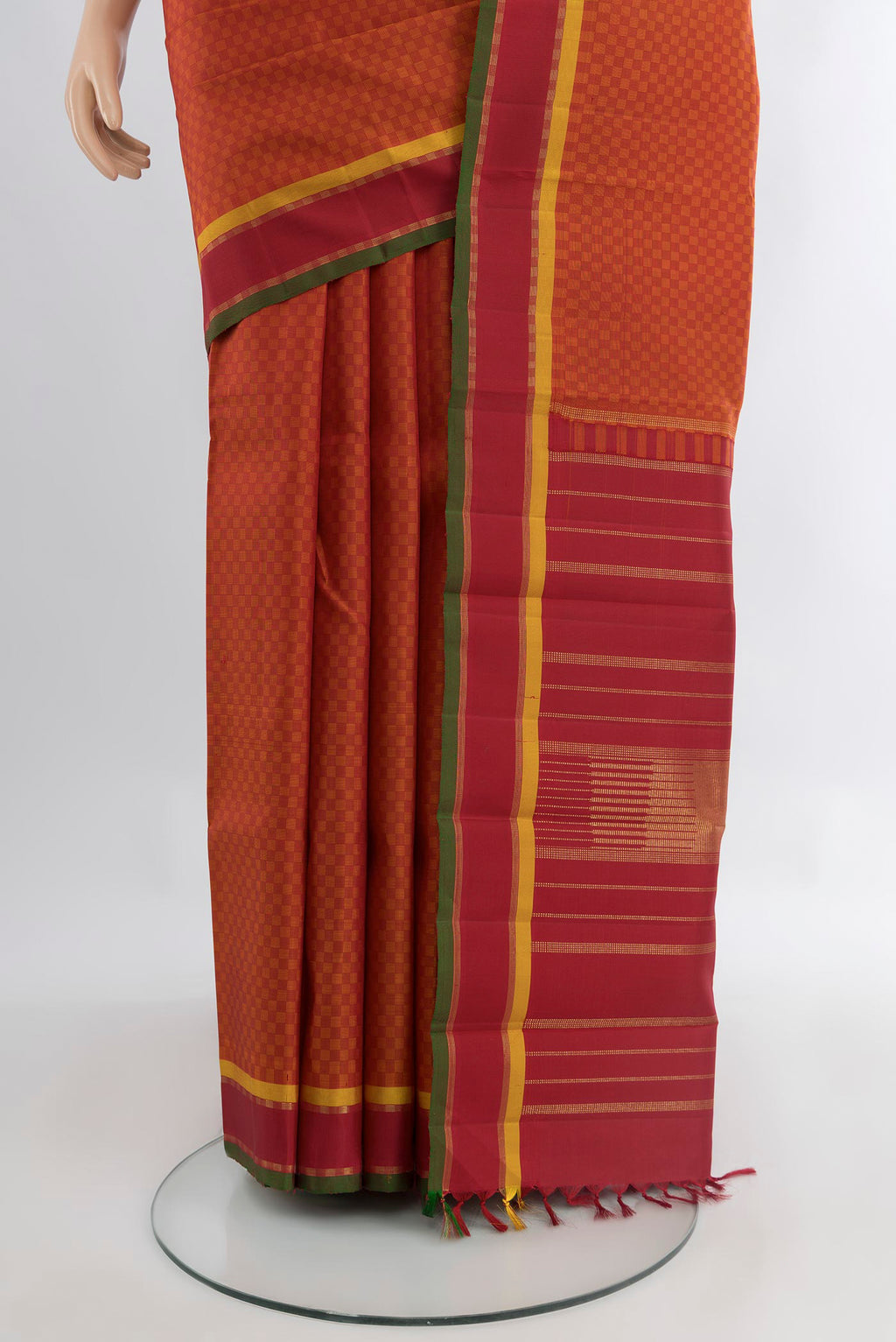 Pleats and pallu of Brick Orange Kanjivaram Silk Saree with Checked design on the body and Zari Border. 