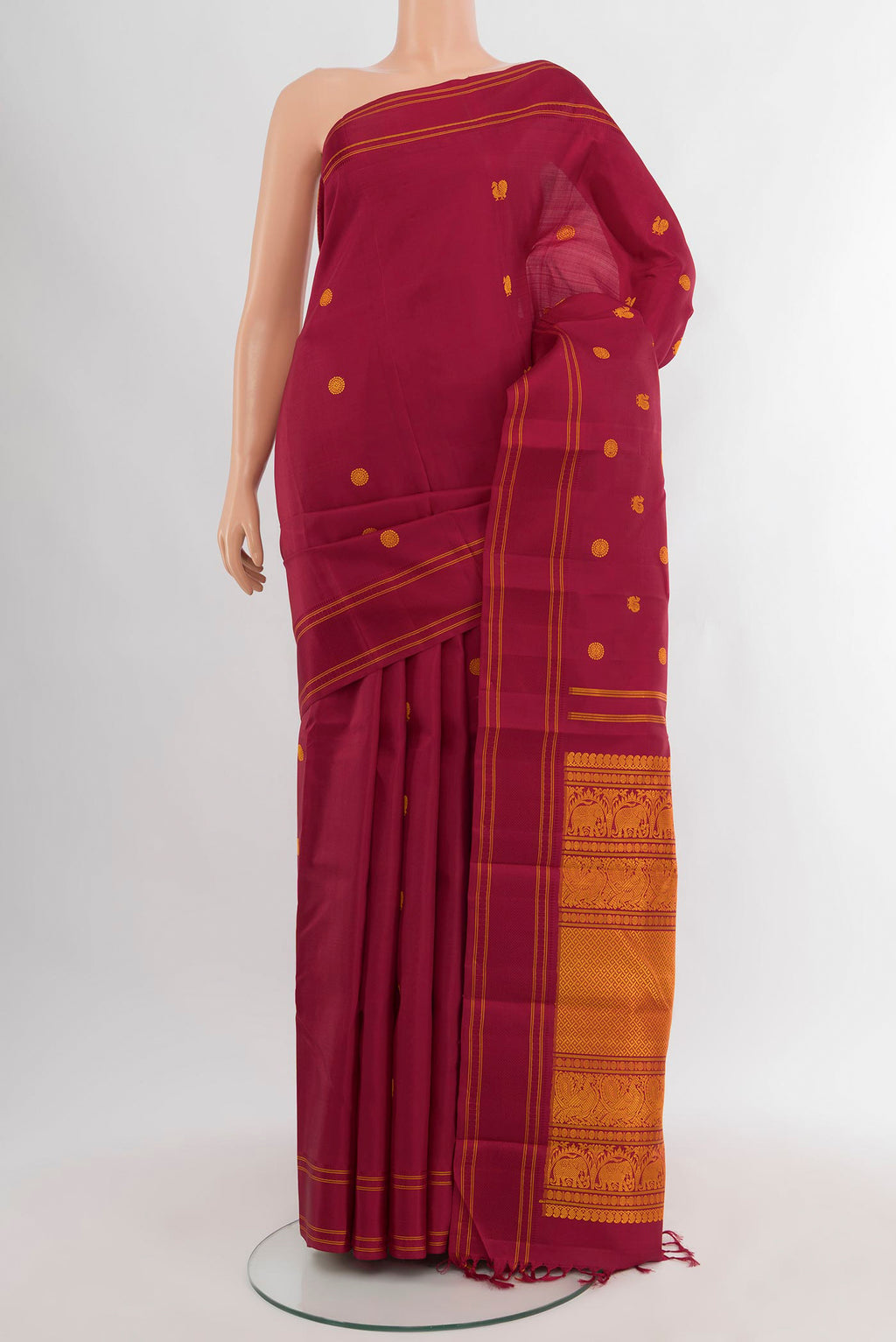 Maroon Kanjivaram Silk Saree with Thread Butta on the body and Plain Border.  displayed on a mannequin