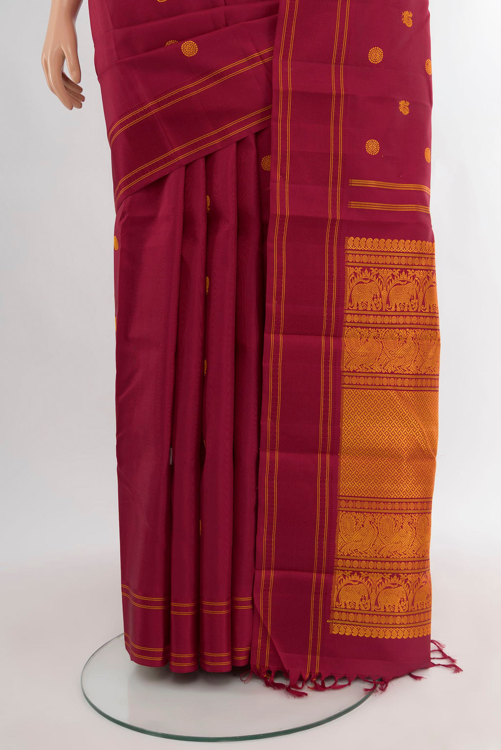 Pleats and pallu of Maroon Kanjivaram Silk Saree with Thread Butta on the body and Plain Border. 