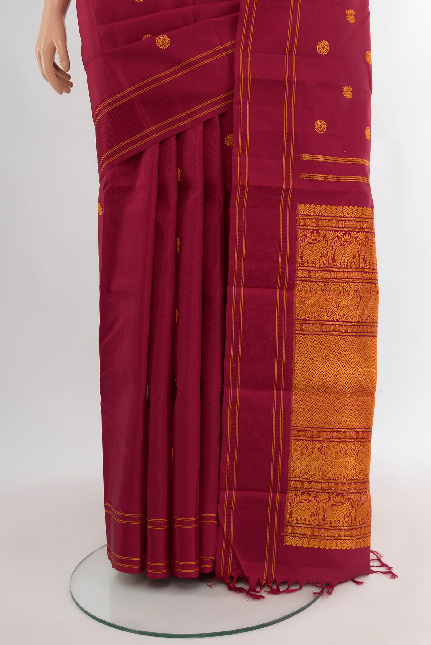 Pleats and pallu of Maroon Kanjivaram Silk Saree with Thread Butta on the body and Plain Border. 