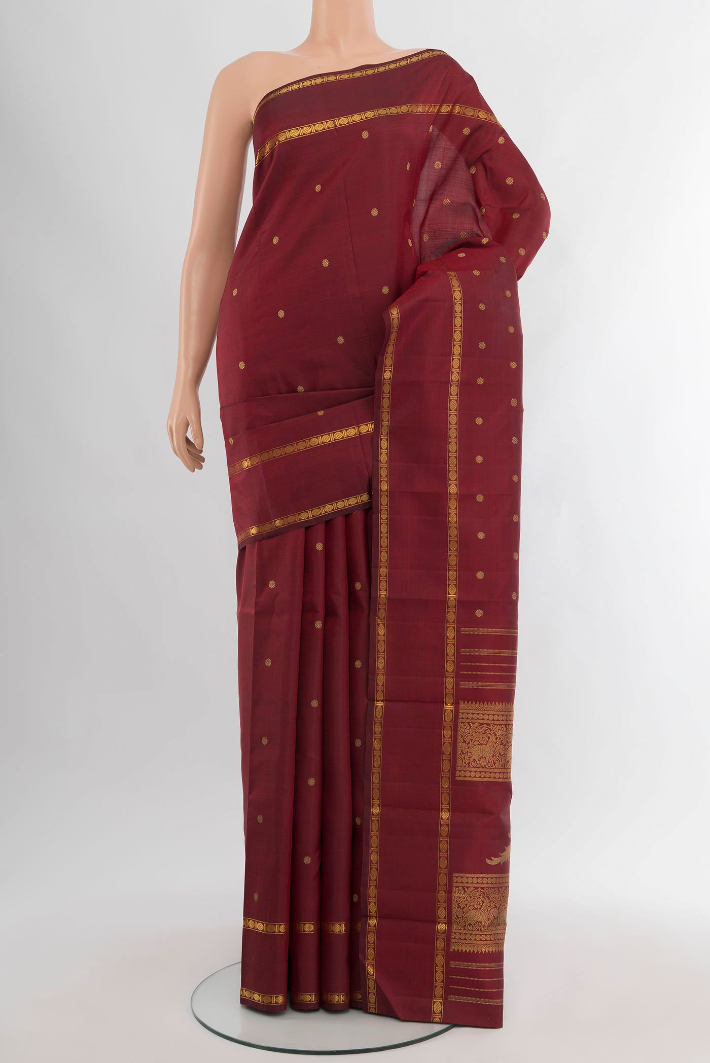 Pure Silk Pure Zari Maroon Kanjivaram Saree with Zari Butta on the body and Zari Border.  displayed on a mannequin