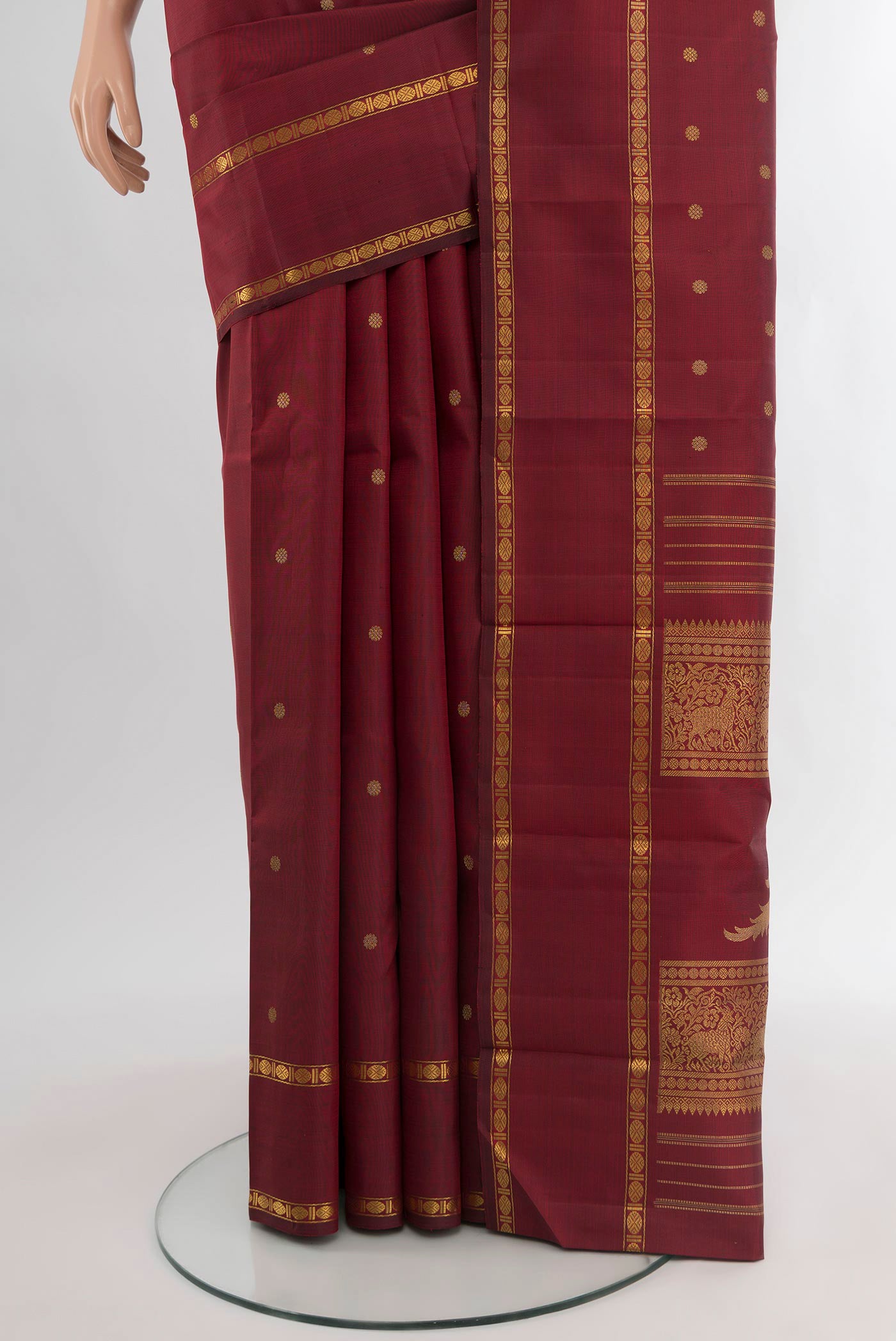Pleats and pallu of Pure Silk Pure Zari Maroon Kanjivaram Saree with Zari Butta on the body and Zari Border. 