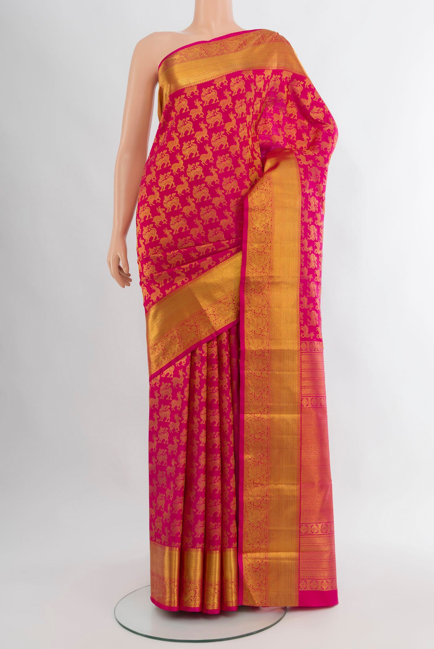 Rani Pink Kanjivaram Silk Saree with Zari Butta on the body and Zari Border.  displayed on a mannequin
