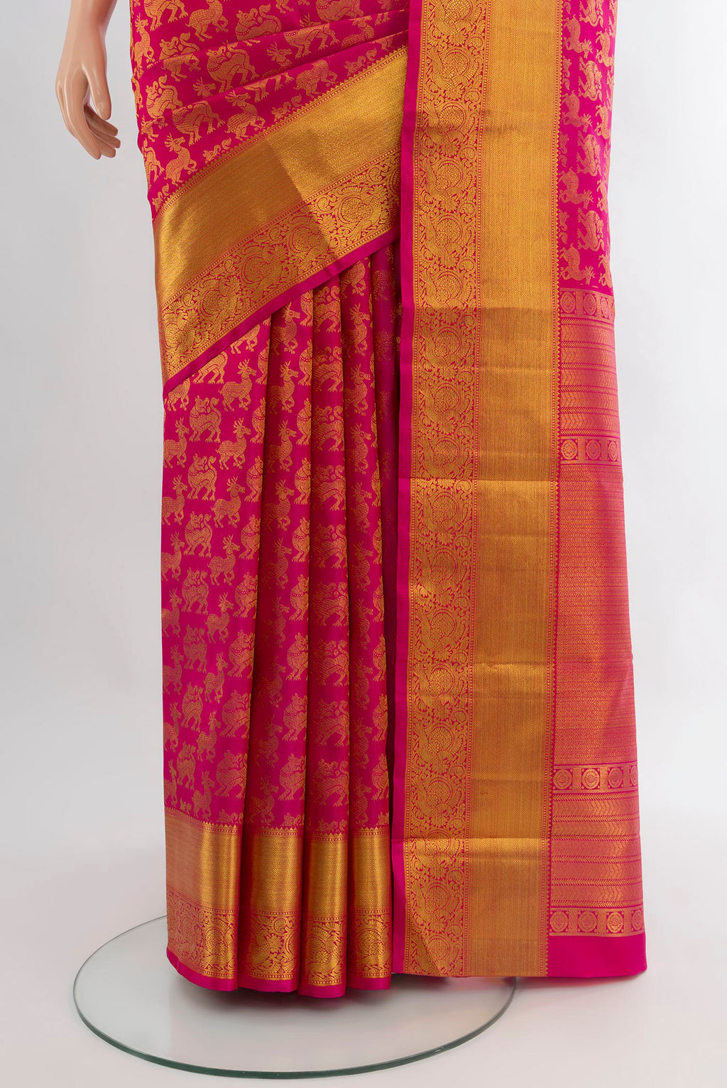 Pleats and pallu of Rani Pink Kanjivaram Silk Saree with Zari Butta on the body and Zari Border. 