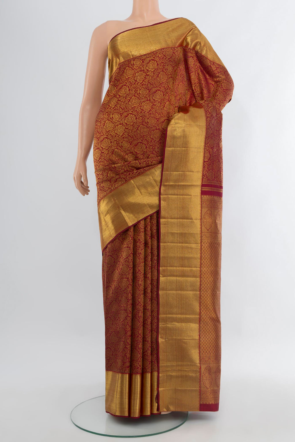 Maroon Kanchipuram Silk Saree with Zari Brocade on the body and Zari Border.  displayed on a mannequin