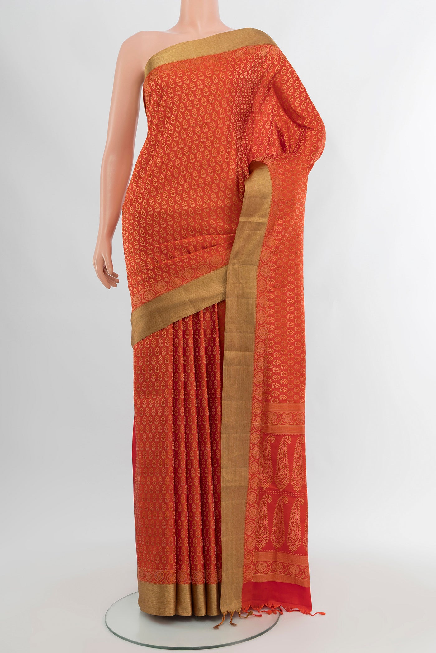 Orange Soft Silk Saree with Zari Butta on the body and Zari Border.  displayed on a mannequin