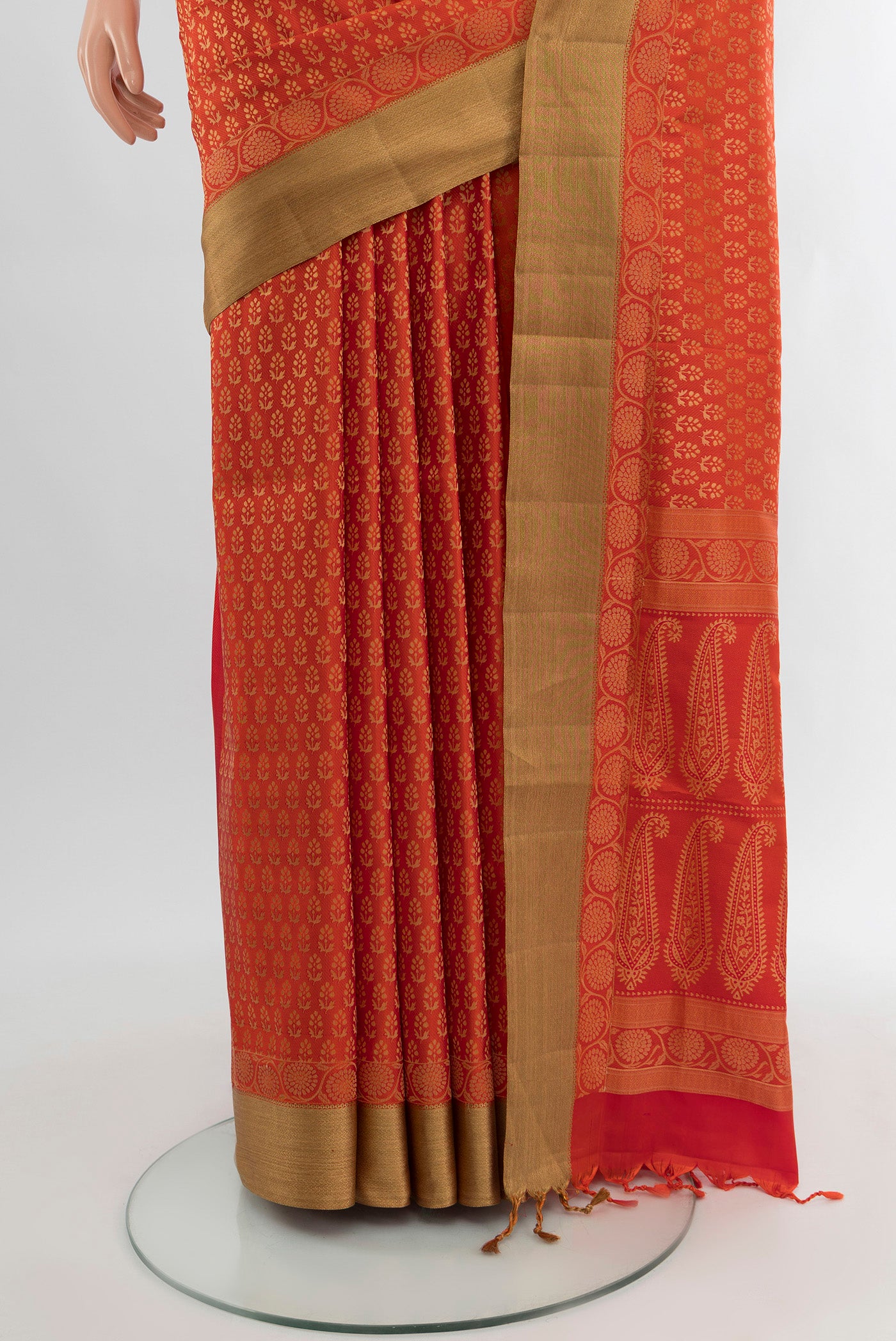 Pleats and pallu of Orange Soft Silk Saree with Zari Butta on the body and Zari Border. 