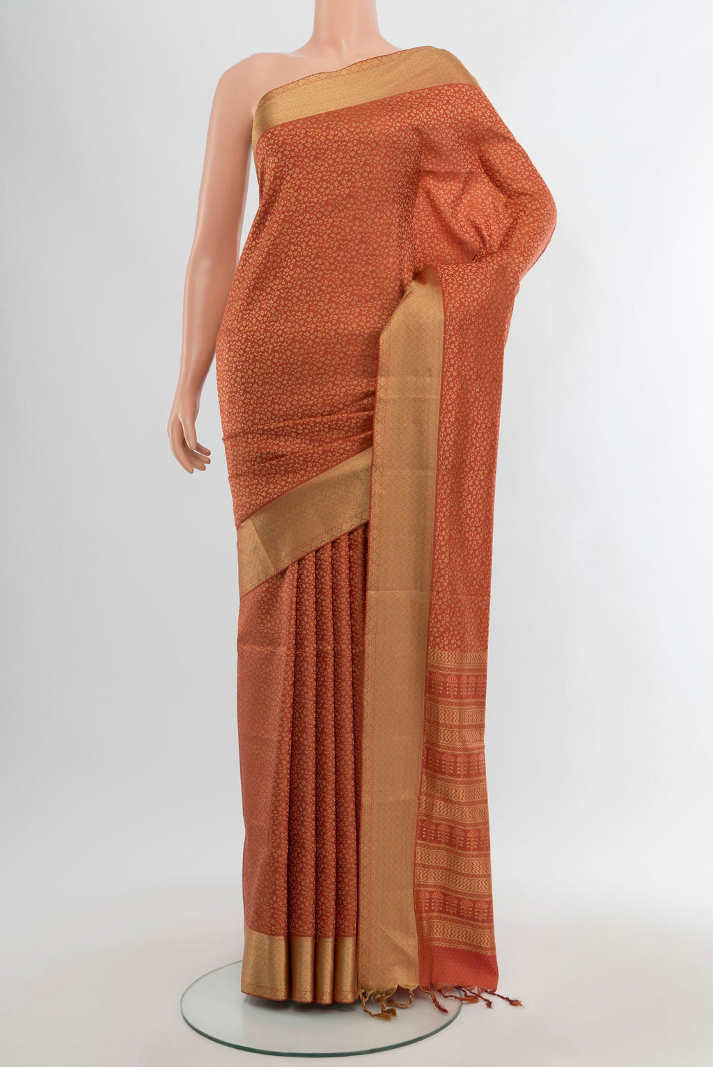 Rust Soft Silk Saree with Jacquard design on the body and Thread Border.  displayed on a mannequin