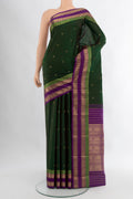 Bottle Green Kanchipuram Silk Saree with Zari Butta on the body and Zari Border.  displayed on a mannequin
