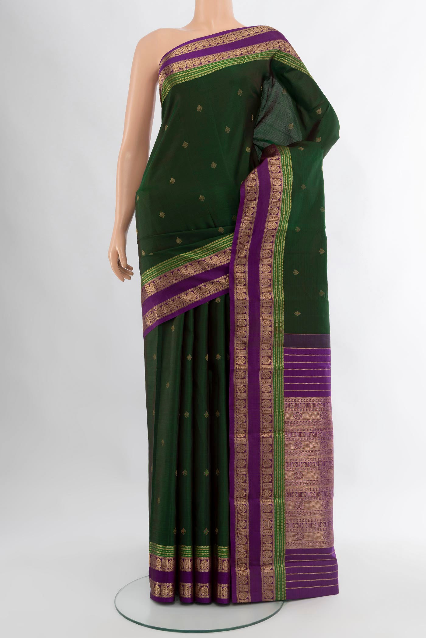 Bottle Green Kanchipuram Silk Saree with Zari Butta on the body and Zari Border.  displayed on a mannequin