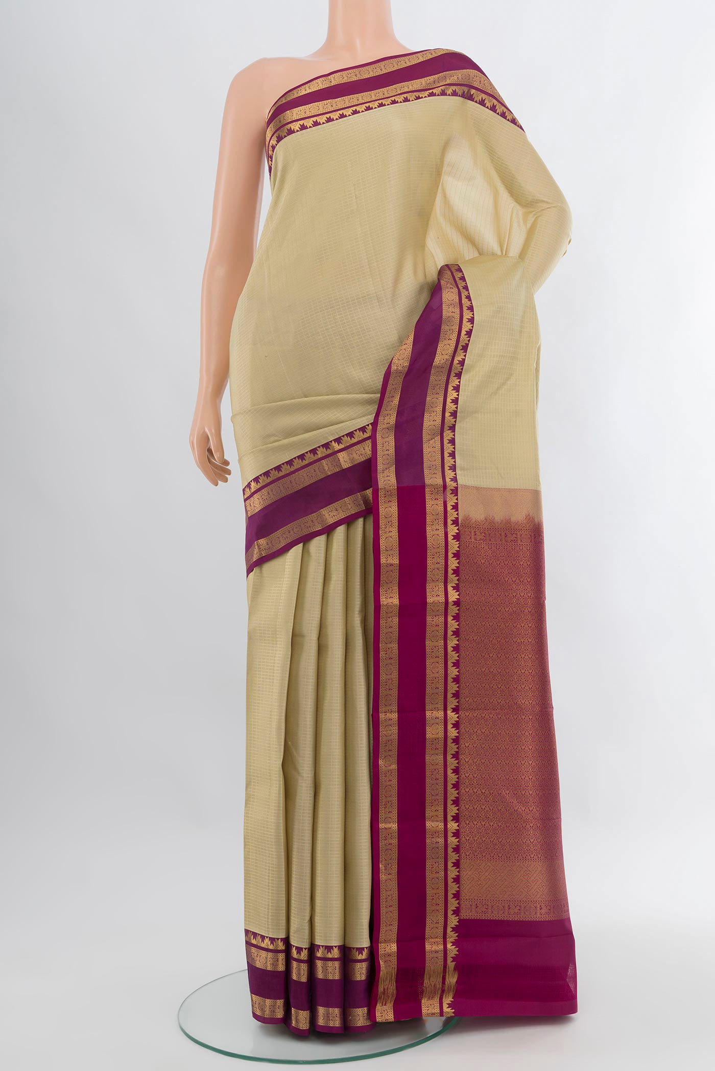 Cream Kanchipuram Silk Saree with Checked design on the body and Zari Border.  displayed on a mannequin