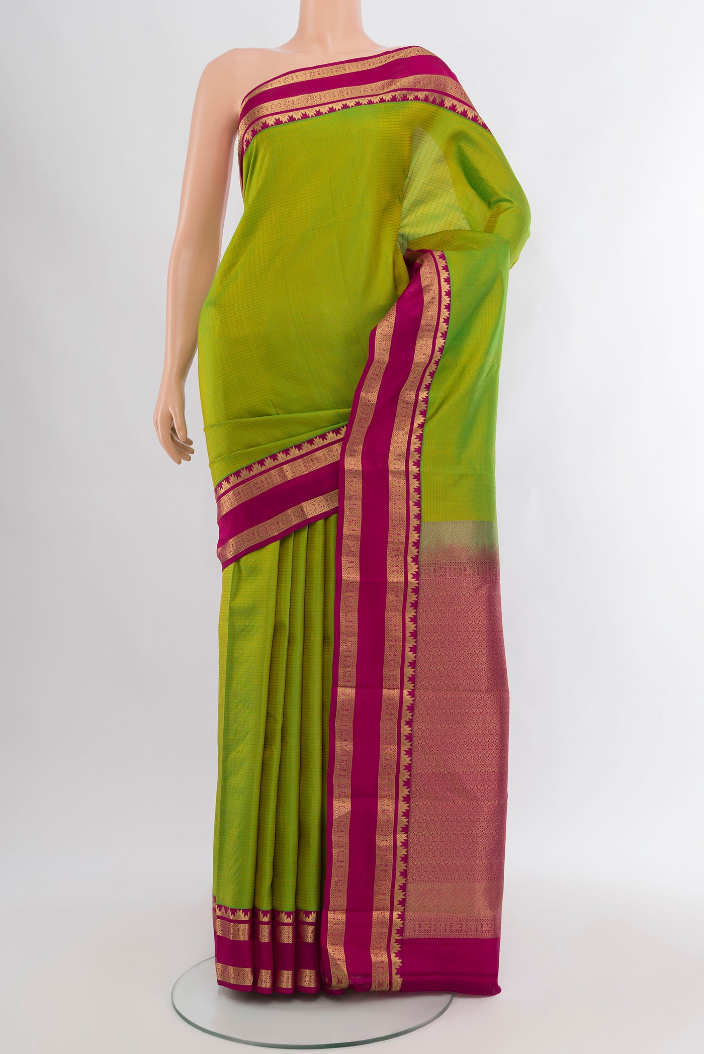 Parrot Green Kanchipuram Silk Saree with Checked design on the body and Zari Border.  displayed on a mannequin