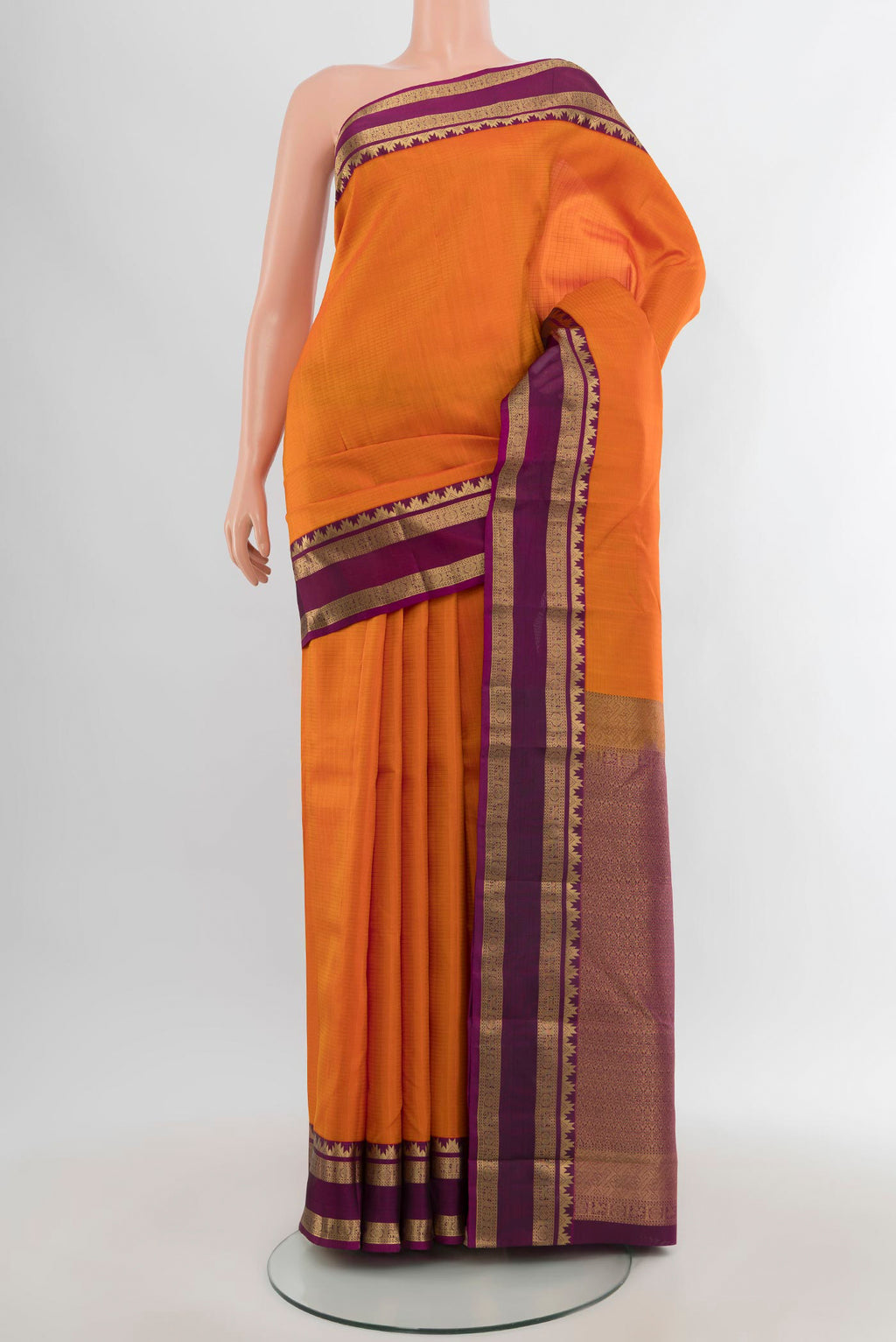 Yellow Kanchipuram Silk Saree with Checked design on the body and Zari Border.  displayed on a mannequin