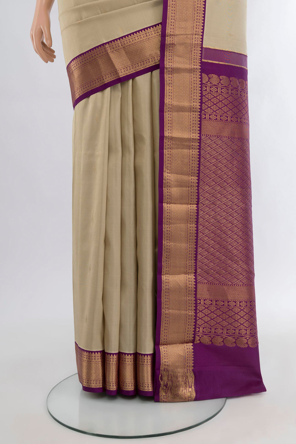Pleats and pallu of Beige Kanchipuram Silk Saree with Zari Butta on the body and Zari Border. 